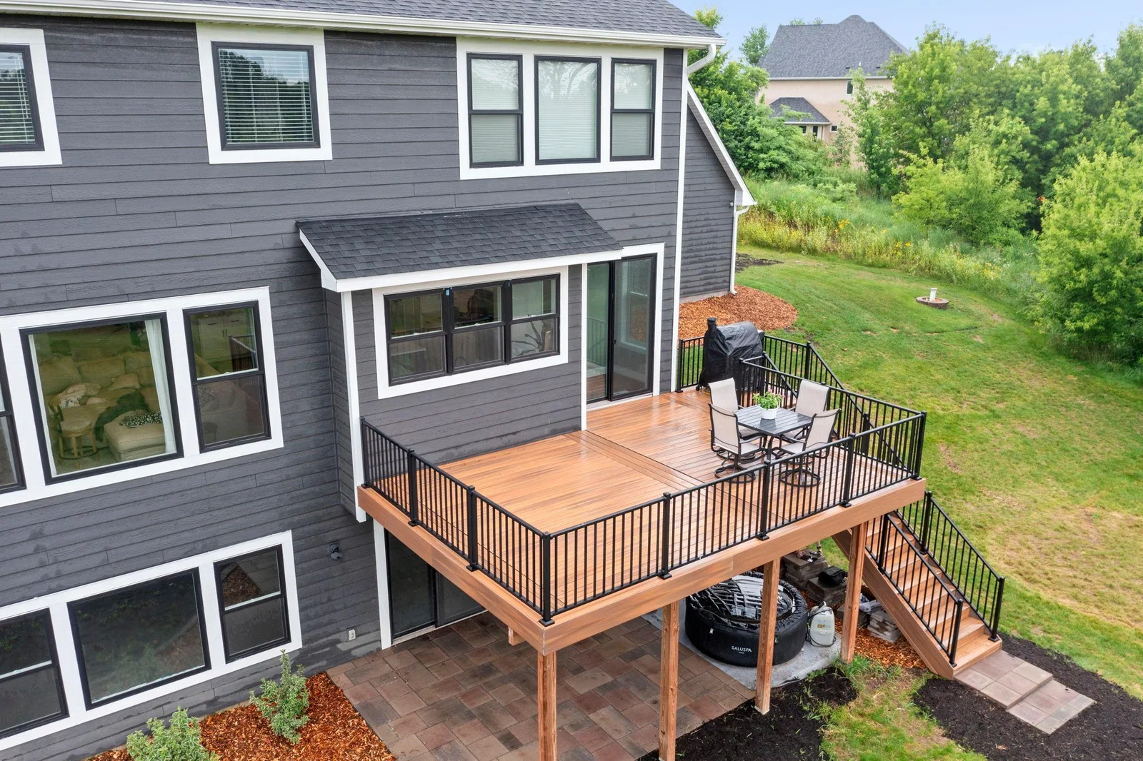 Another perspective of the home's beautiful rear exterior, showcasing the spacious deck and patio—ideal for outdoor living and entertaining.