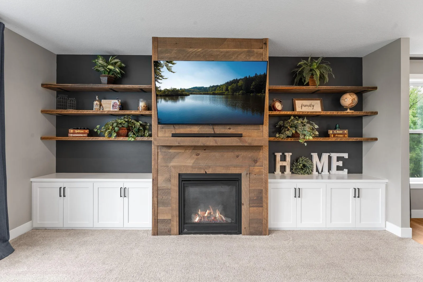 A beautiful angle showcasing the stunning fireplace and custom built-ins in the main-level living room.