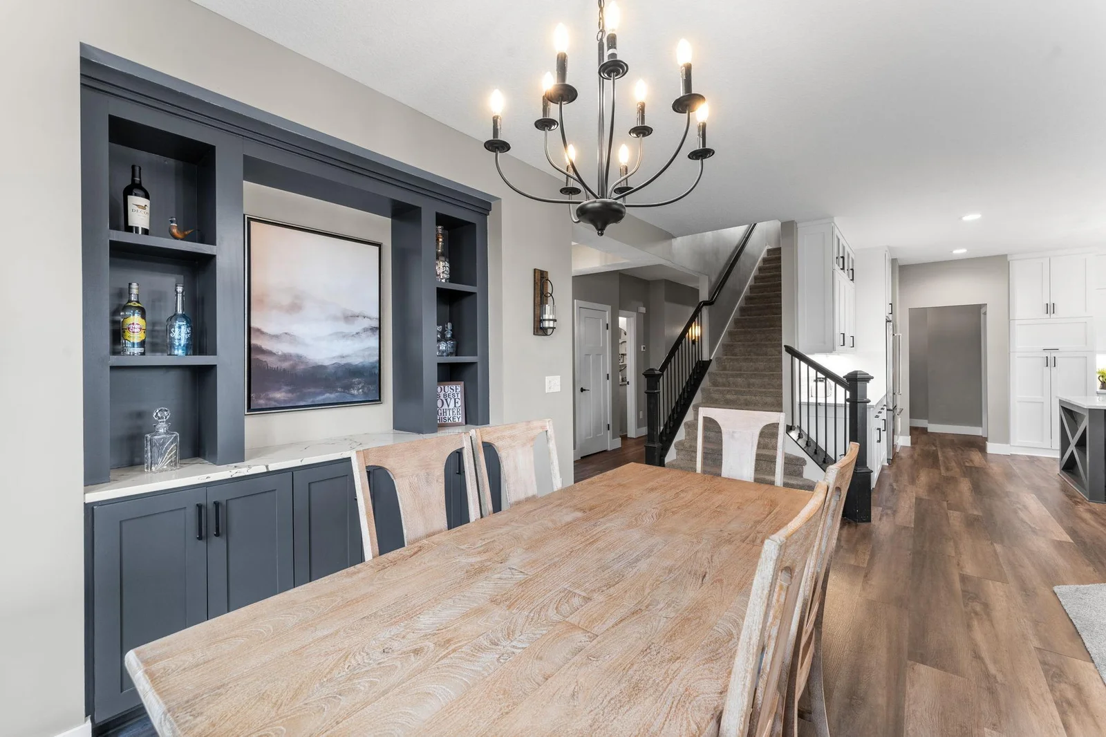 This beautifully designed dining room space featuring classic touches, built-in storage, and warm luxury flooring throughout.