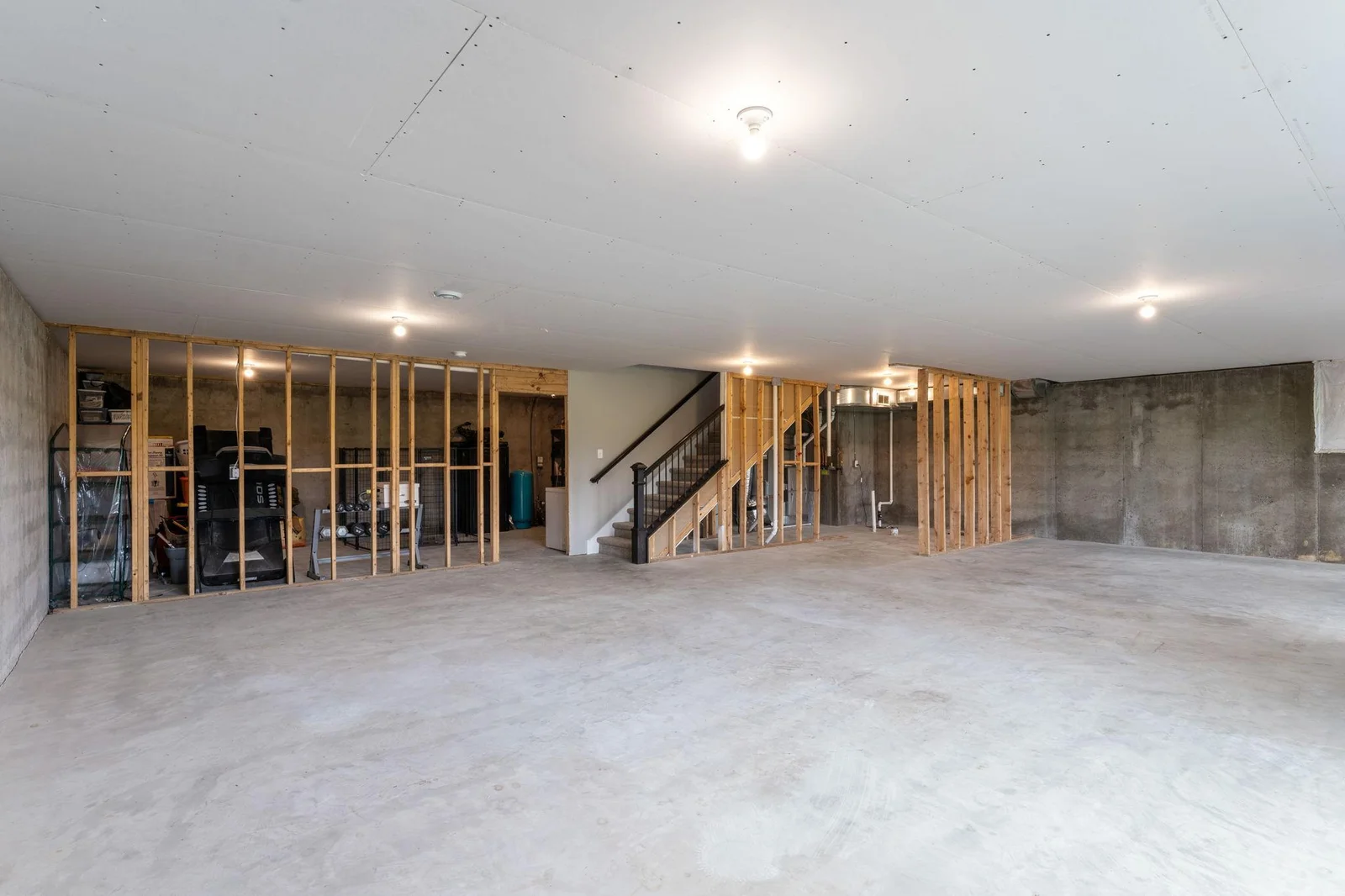 The large unfinished basement with a walkout to an expansive concrete patio is ready for your future finishing project.