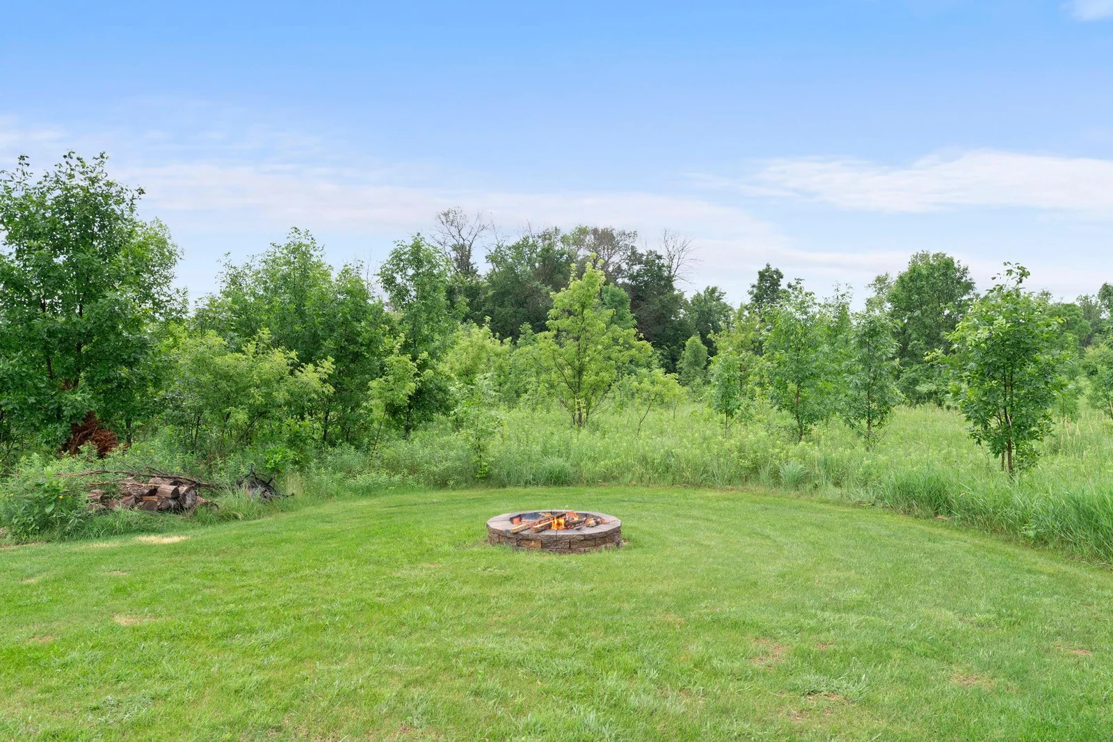 A cozy firepit area in the backyard, perfect for relaxing on summer nights.
