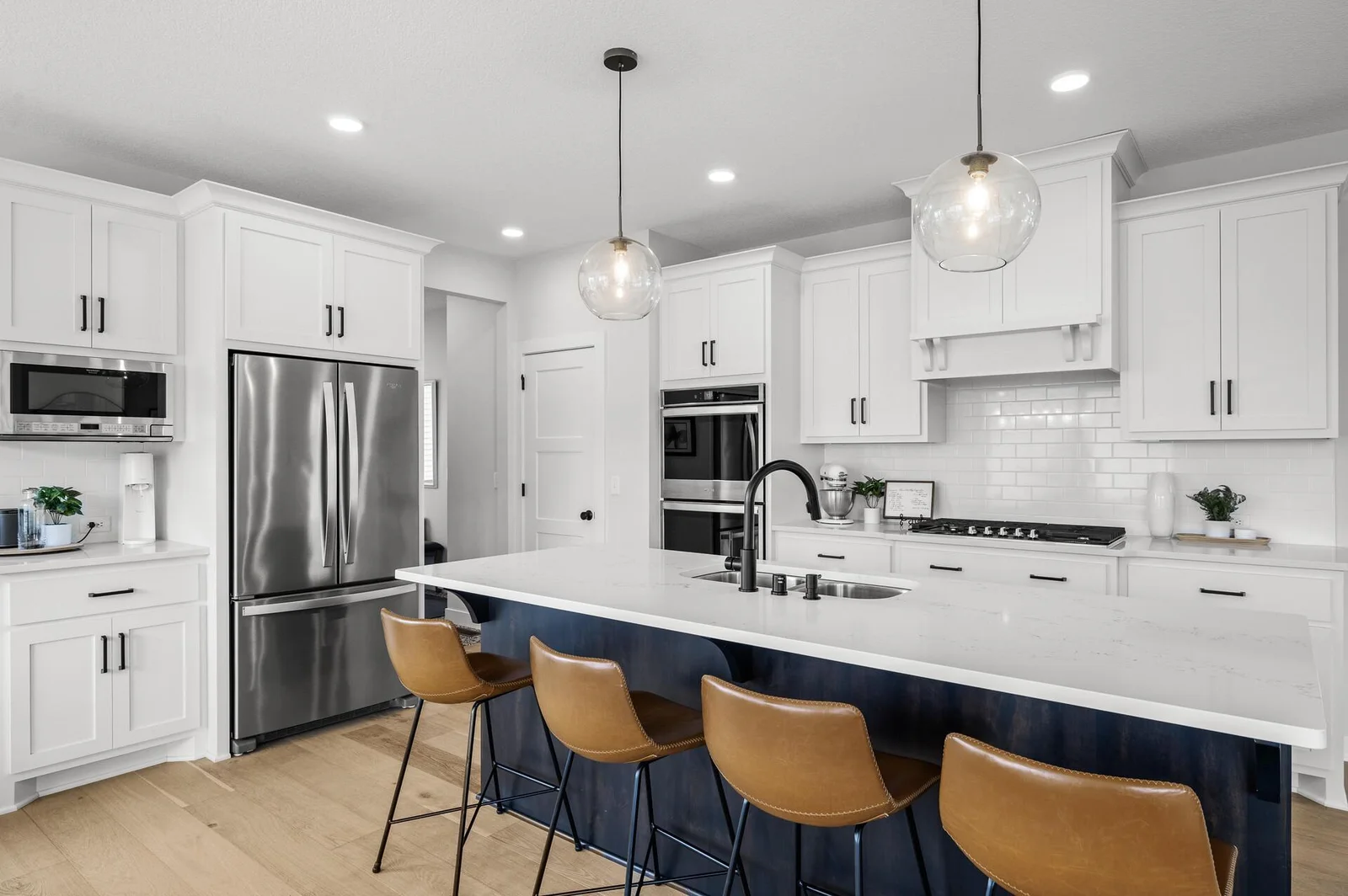 Double wall ovens, large center island and dedicated pantry are some of the perks to this gorgeous kitchen!