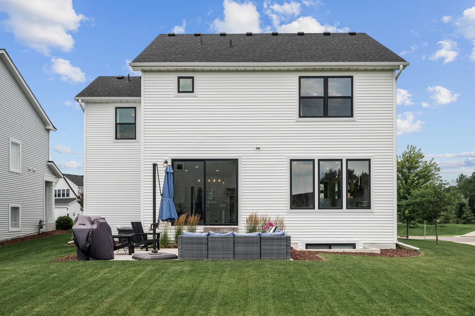 Smart looking home with big windows and large sliding door.