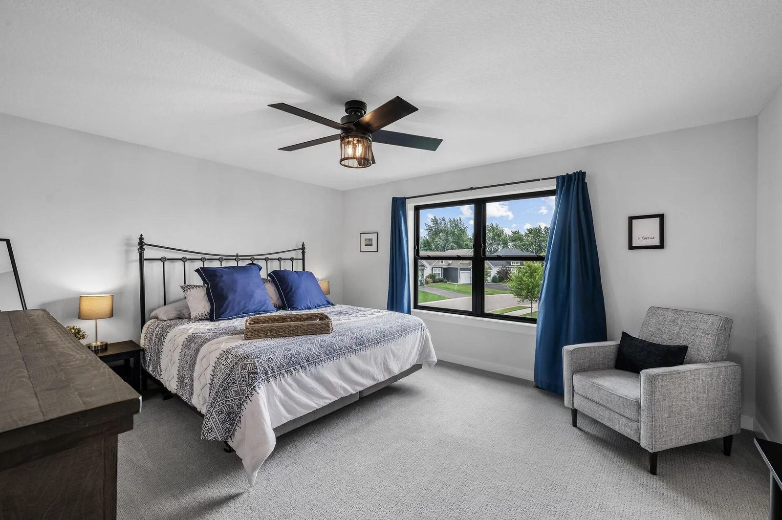 Primary bedroom is spacious! Note the overhead fan/light combo.