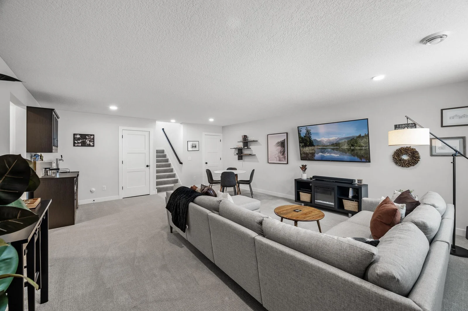 Head down to the lower level, and you will find your family room! Another entertaining spot! Behind those two doors are storage options.