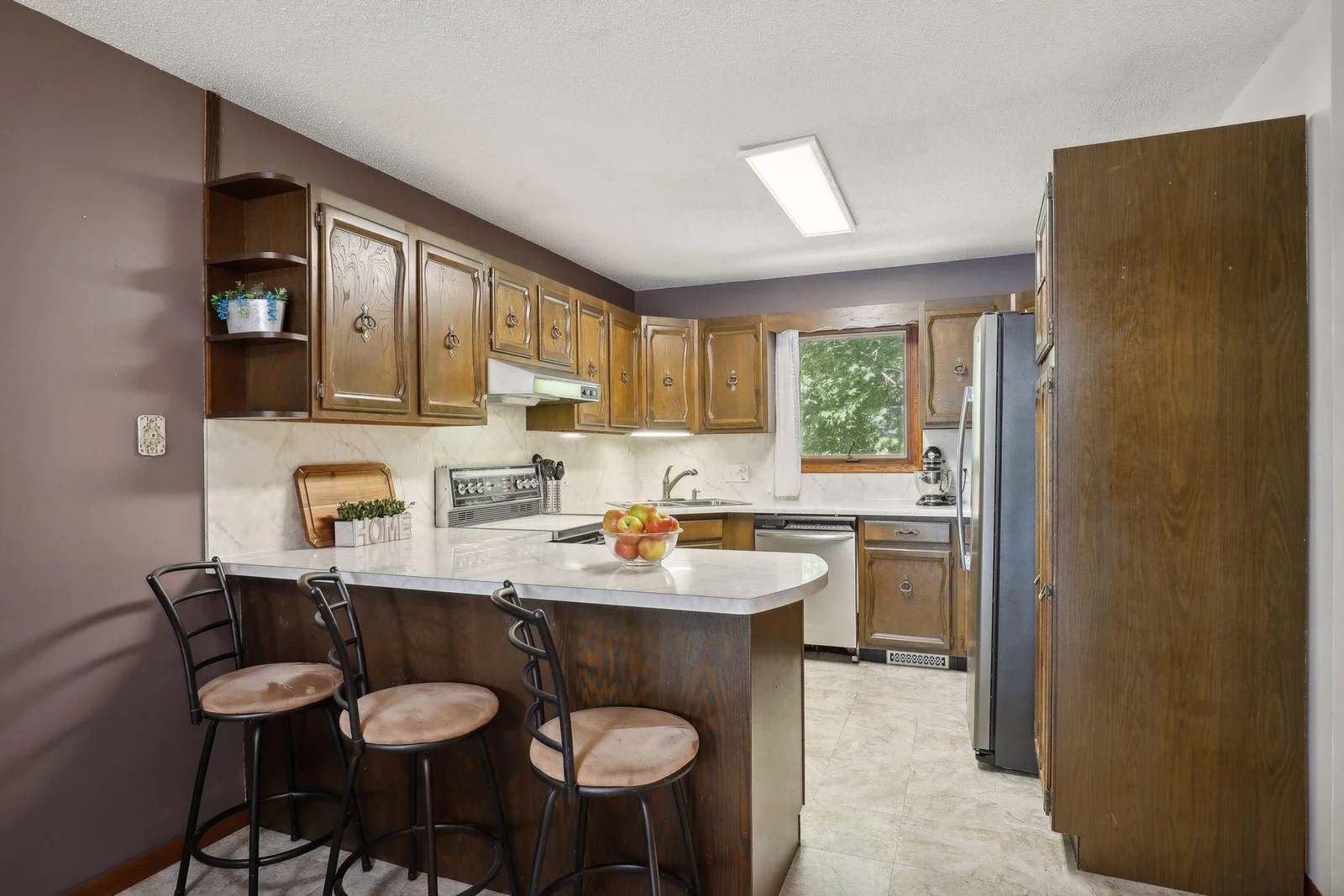 Upper level full kitchen with island and bar seating