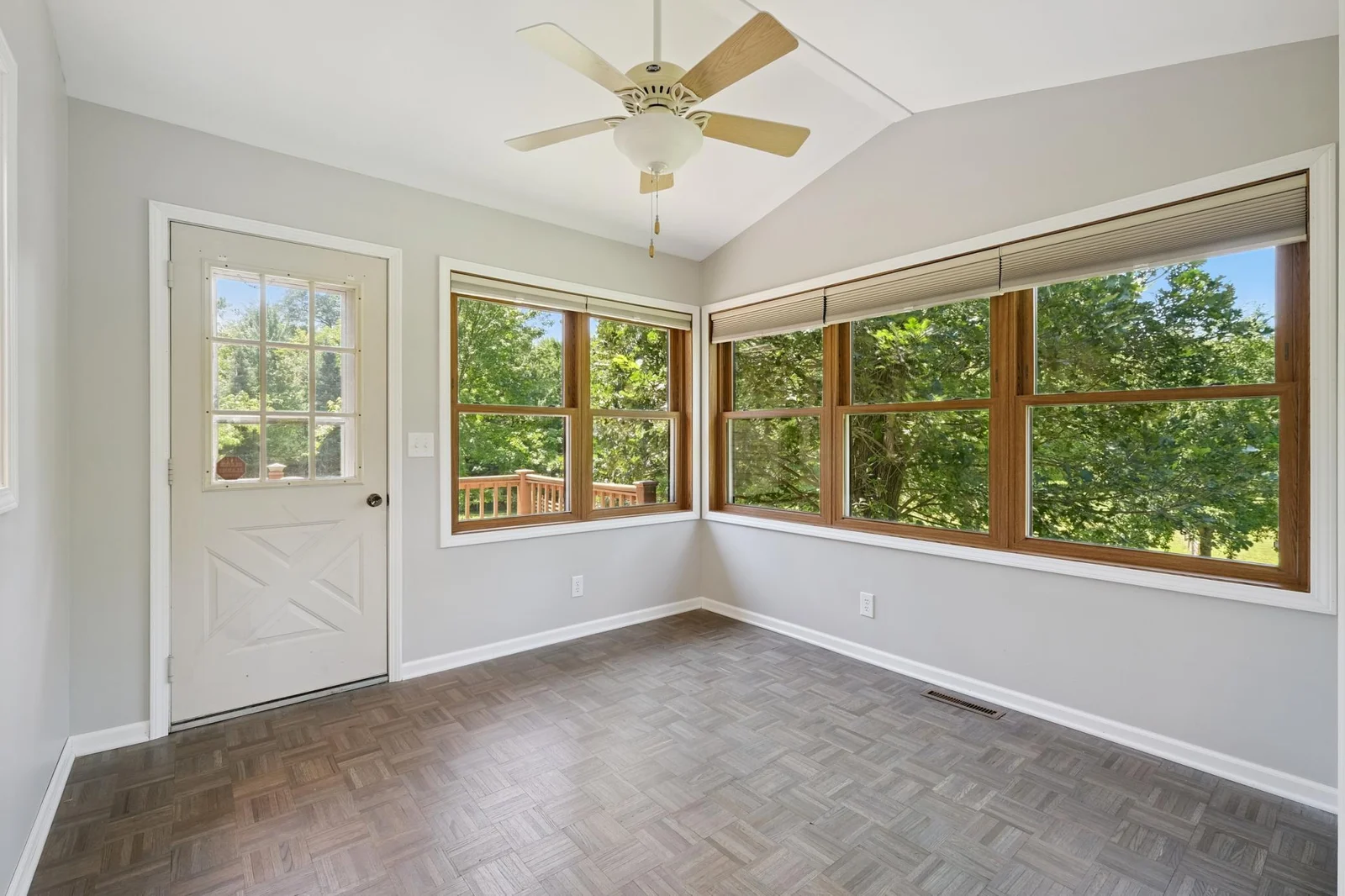 Bright sunroom that opens to a deck