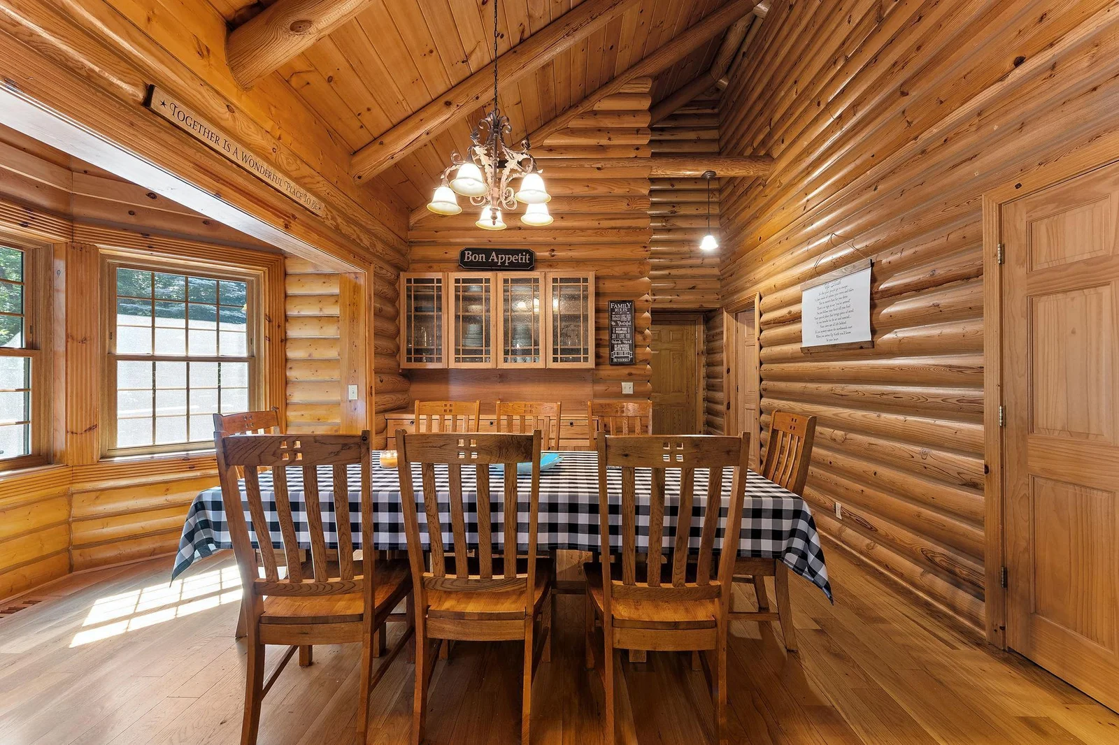 Separate dining area has vaulted ceiling and new bay windows.  Built-in cabinets are ready for your holiday entertaining or potluck - great storage.  Note the pantry door to the right.