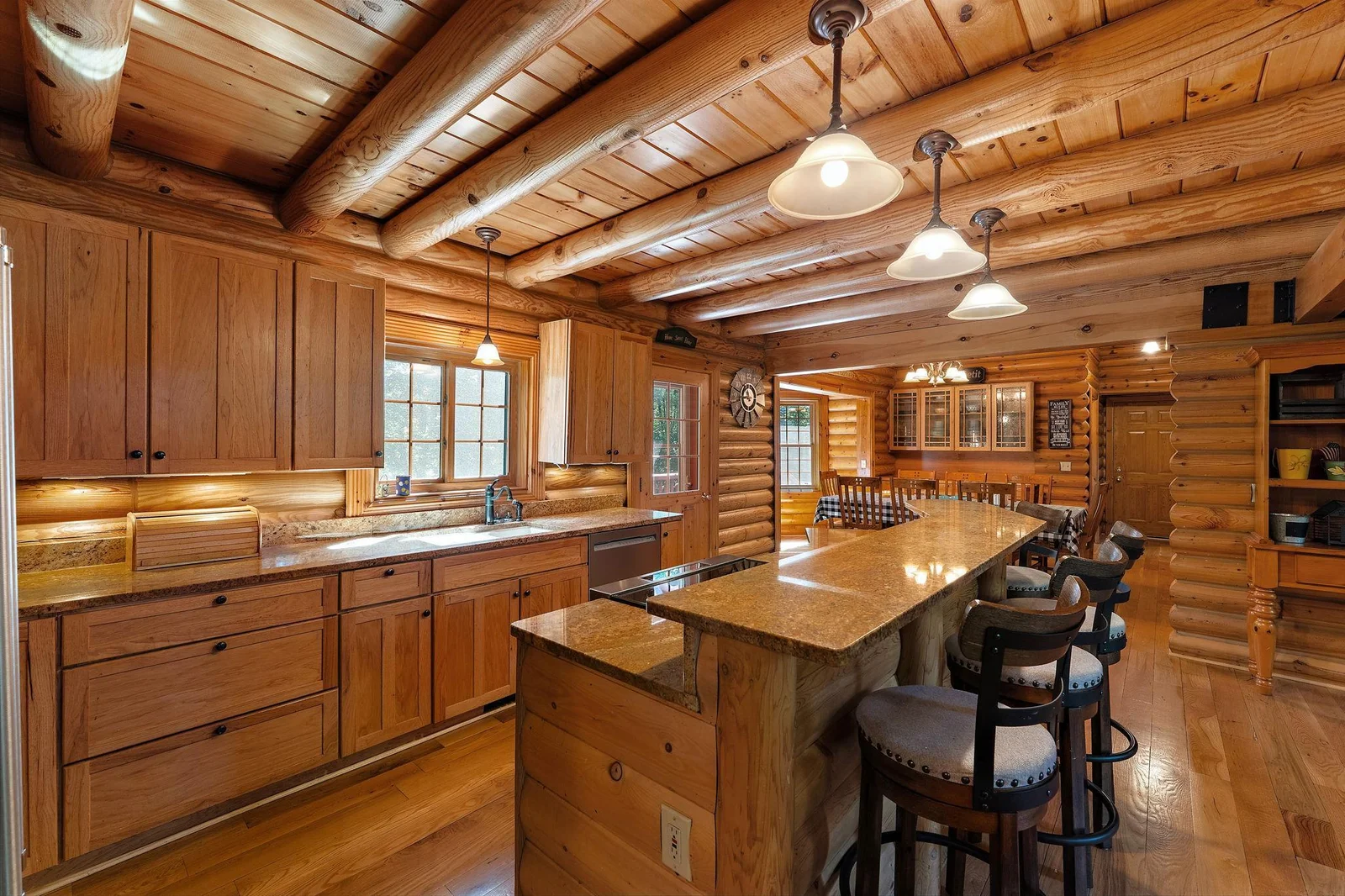 Breakfast or snack nook is perfect off the kitchen island for quick meals.  Plenty of drawers for storage, under-counter light, and pendent lights brighten up this room.  New kitchen window.