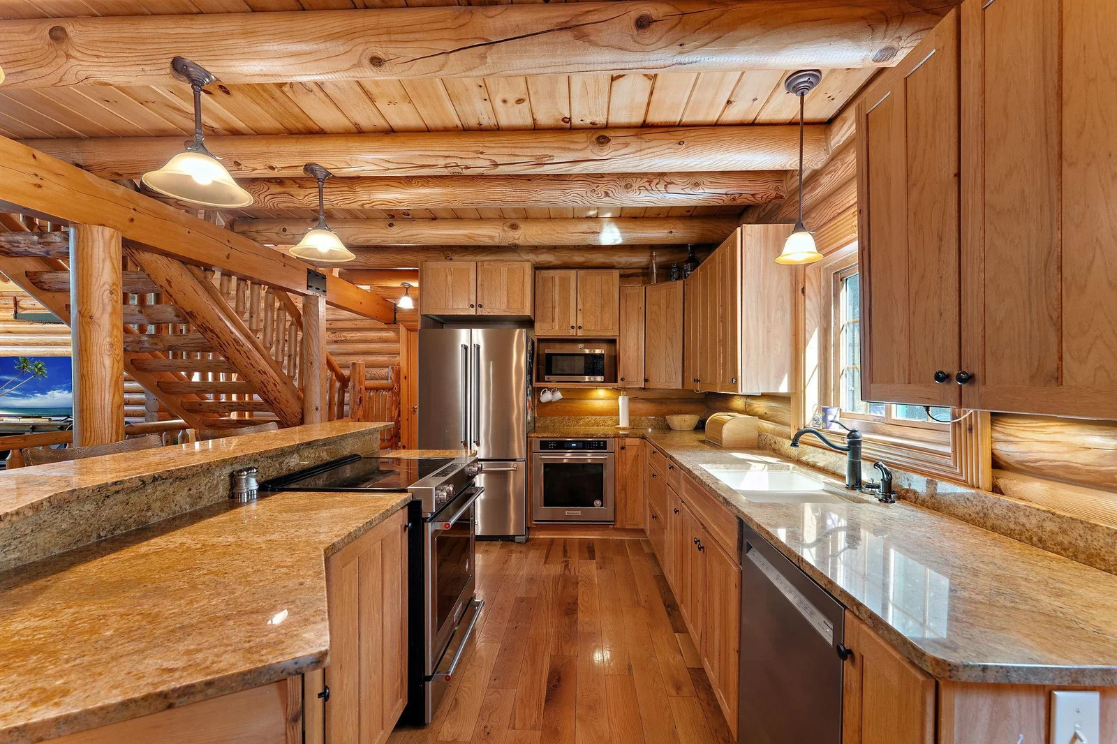 Kitchen is ready for entertaining!  Large island, two ovens, plenty of storage in the hickory cabinets and granite counters for all your food prep!  Pantry closet is just off the kitchen.