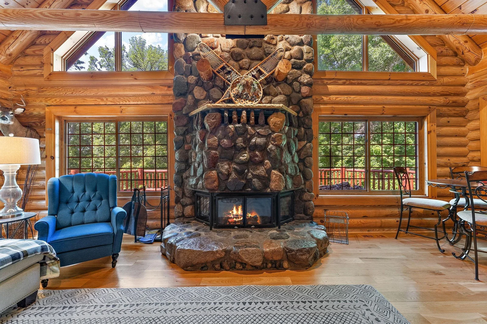 Two-story hand-picked stone fireplace is impressive inside and outside the home