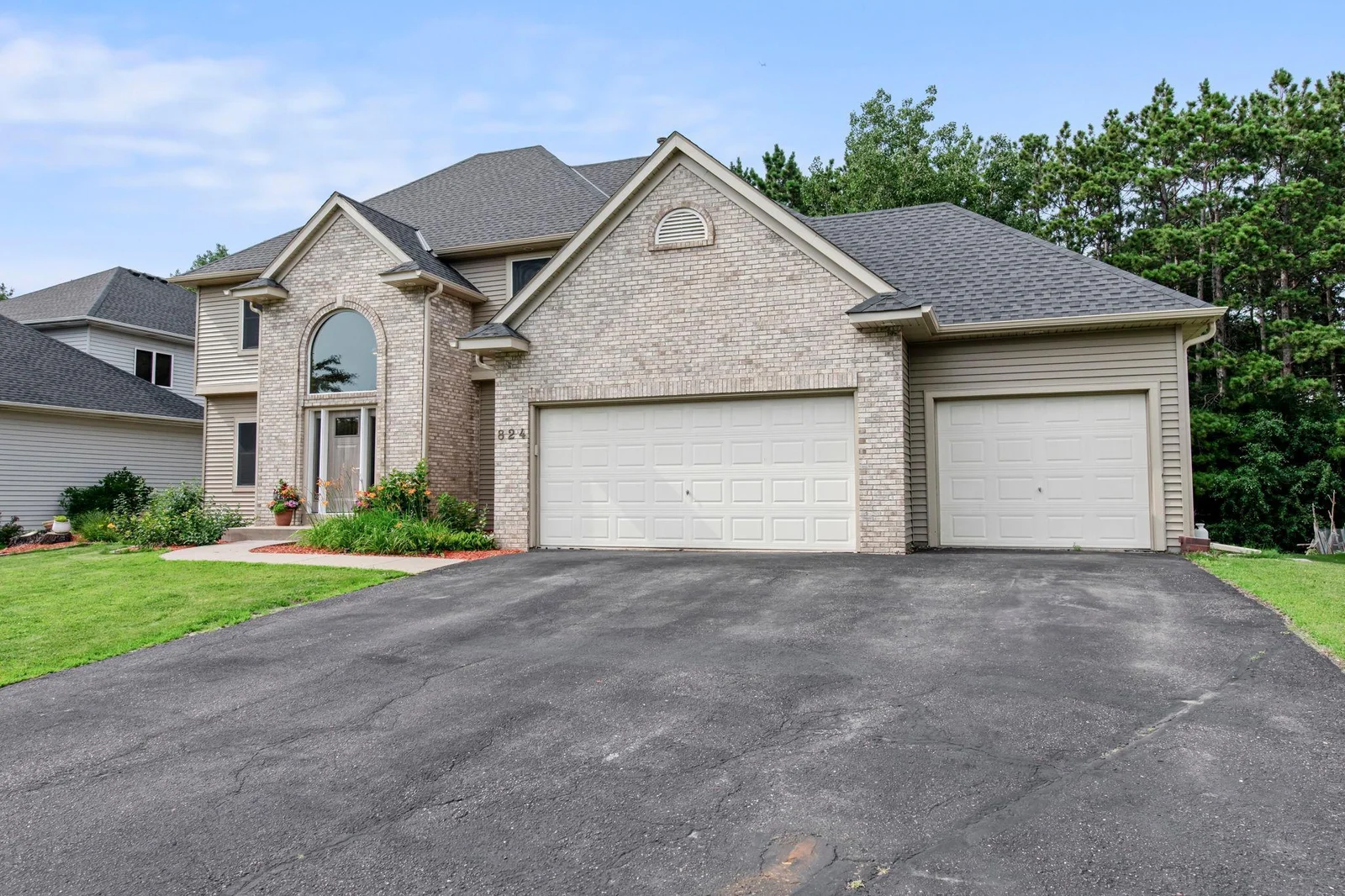 This home also features a large driveway and garage
