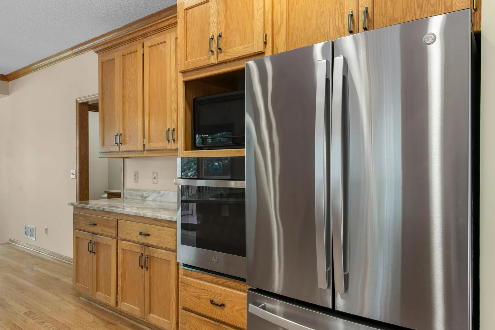 Kitchen features updated stainless steal appliances