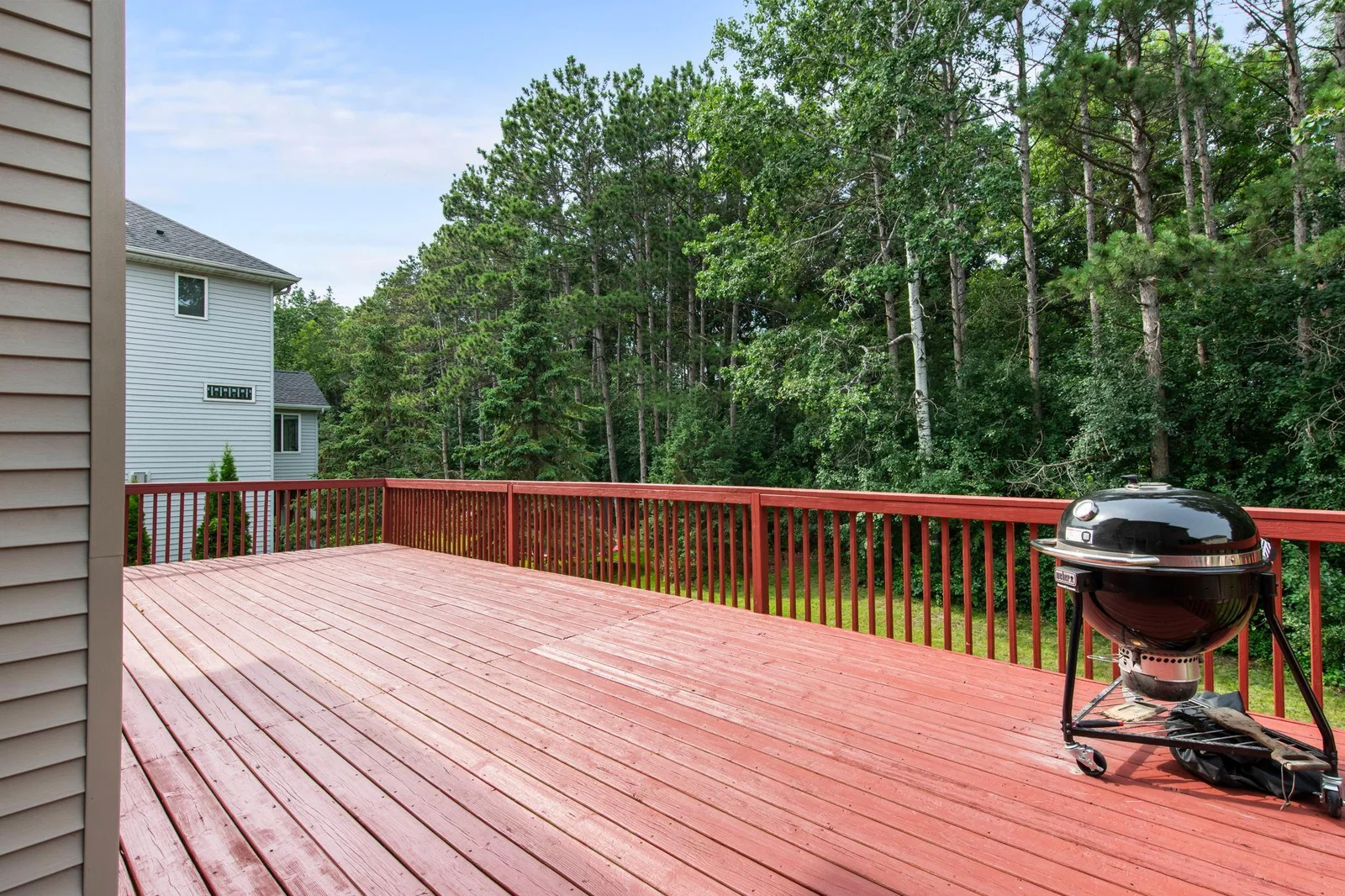 Back deck area looks out to beautiful green space