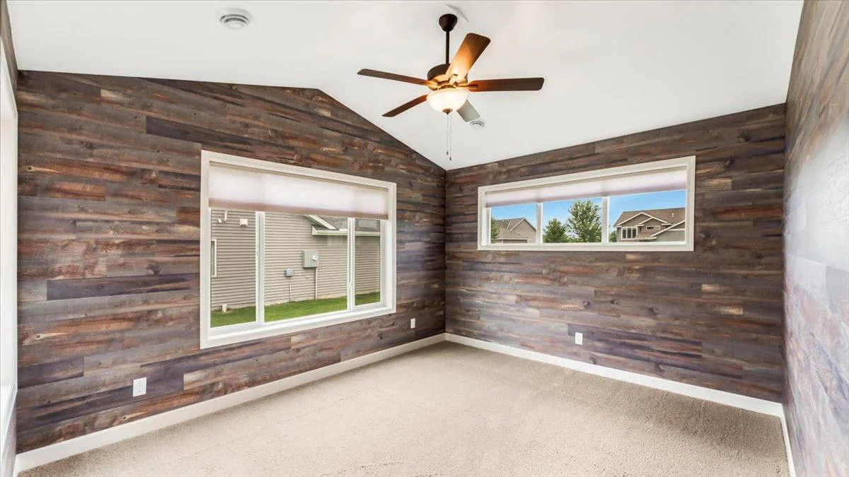 Another living space that acts as a sunroom with windows surrounding it.