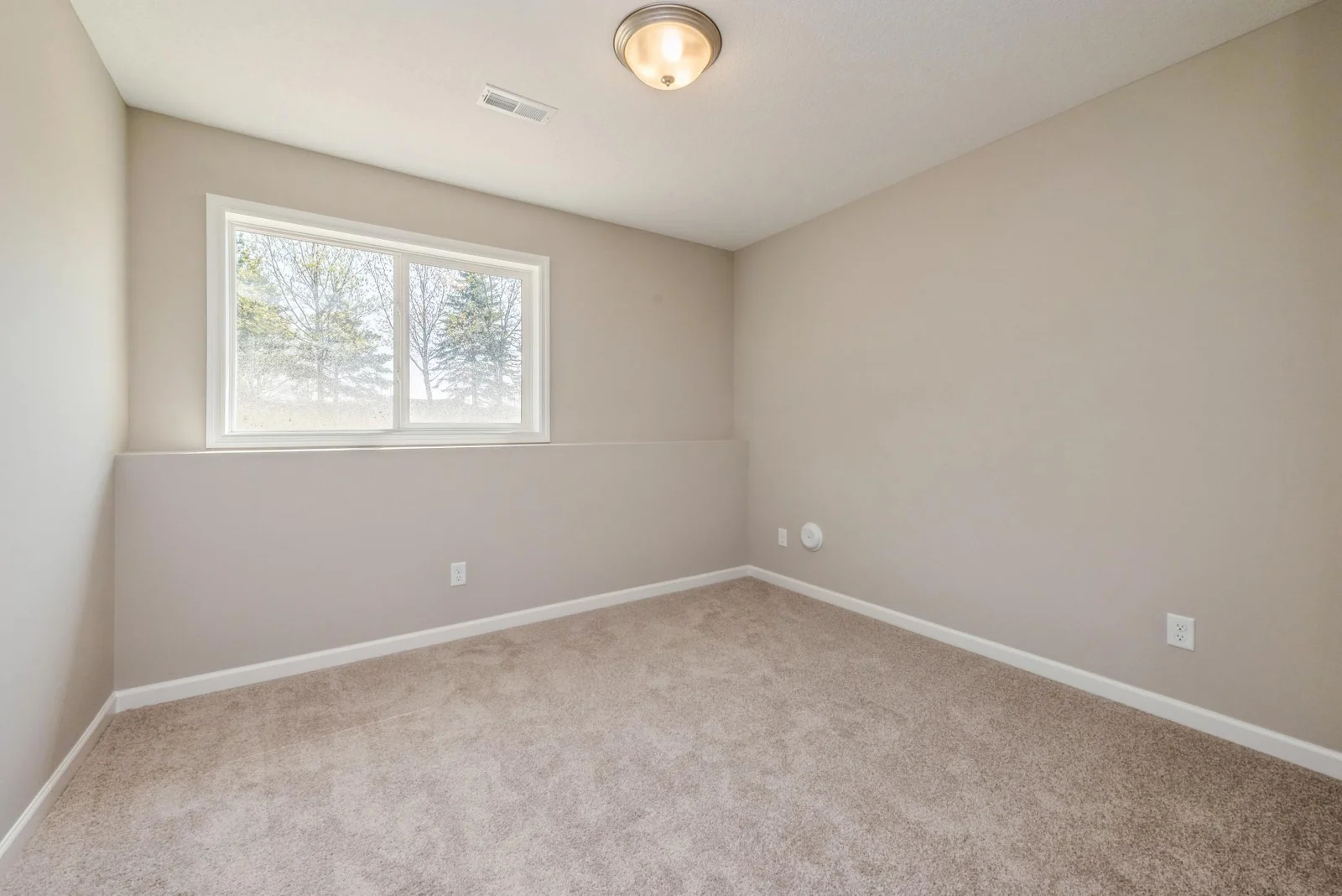 Lower Level Bedroom. Photo is of former model home. See Sales Consultant for Specific Colors and Options. Ability to choose!