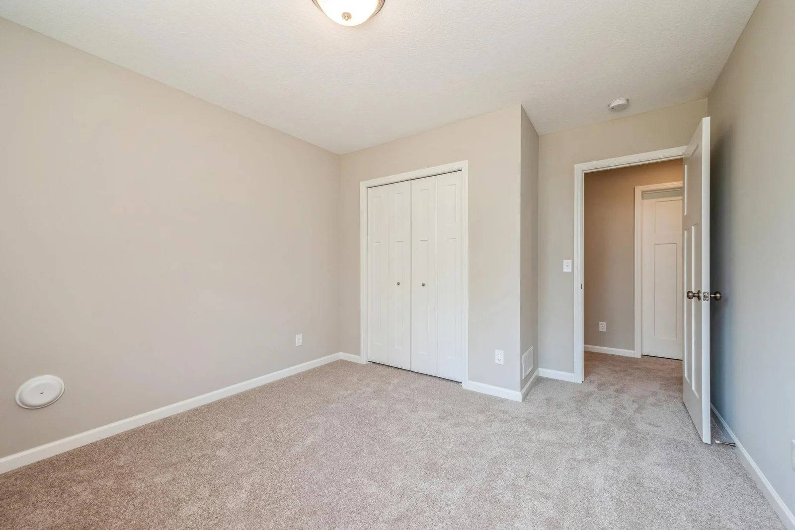 Lower Level Bedroom. Photo is of former model home. See Sales Consultant for Specific Colors and Options. Ability to choose!