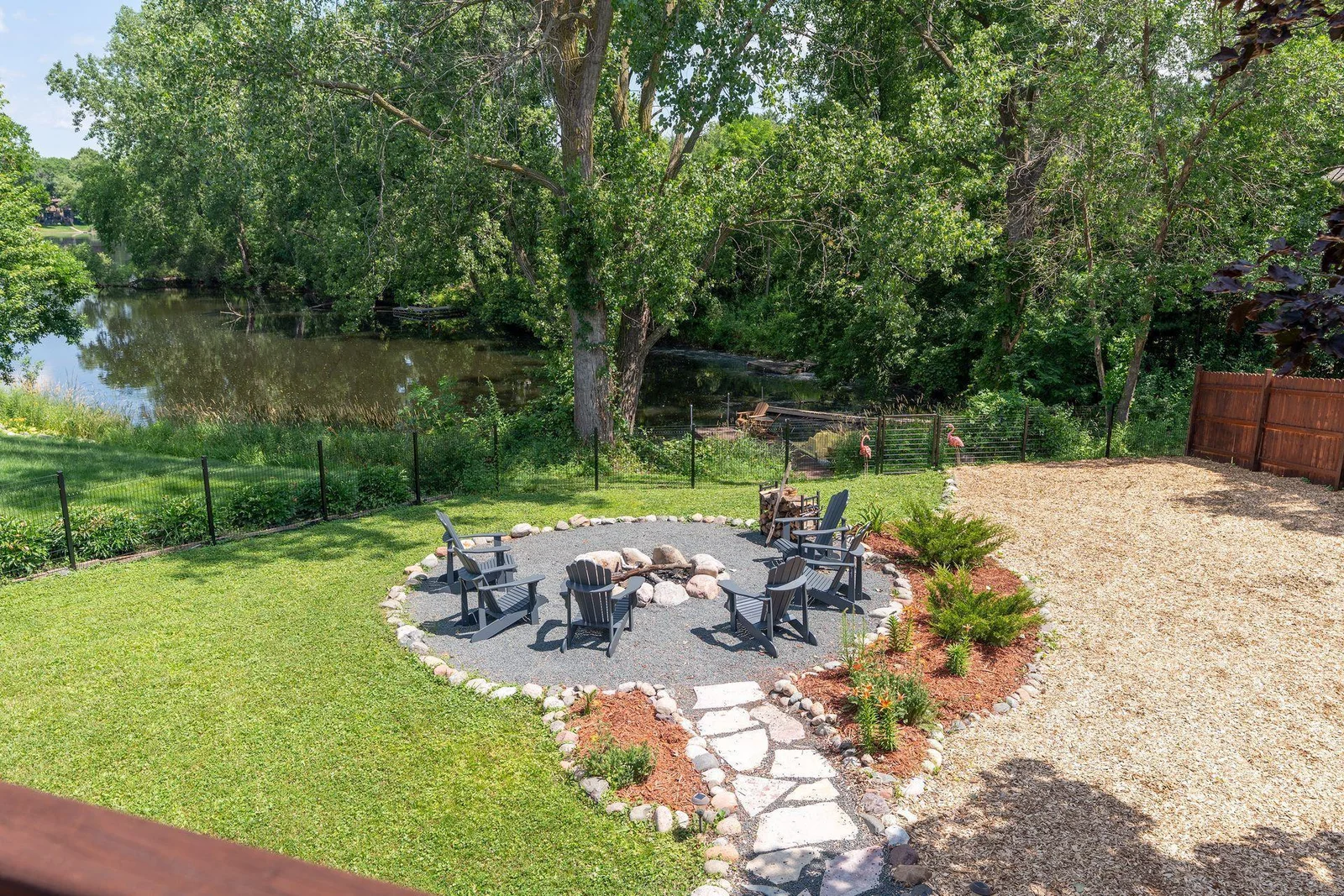 Beautifully sculpted backyard w/wood privacy fence, raised garden beds, chicken coop, firepit & peaceful pond, which is part of Evergreen Ponds & connects to Kerry Lake so bring your kayak!