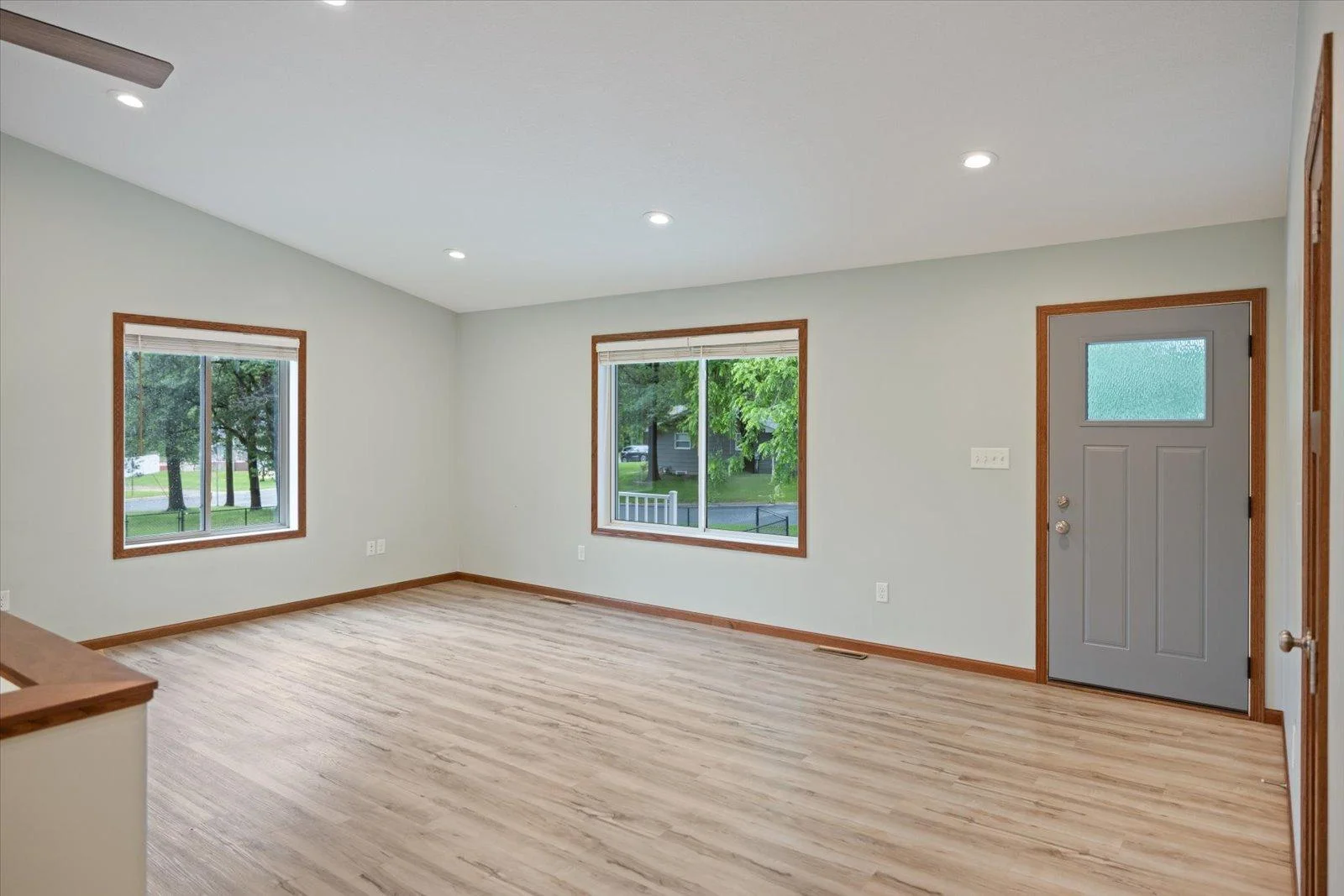 Another view of the living room, showcasing lots of windows to let the natural light in.
