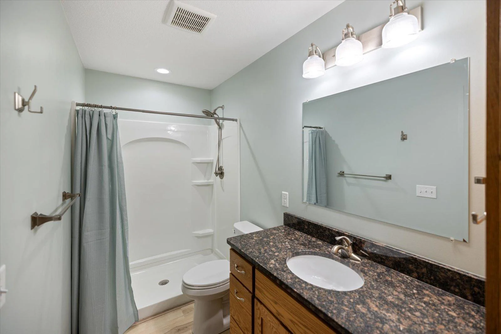 The walkthrough bathroom in the main level with a large walk-in shower.