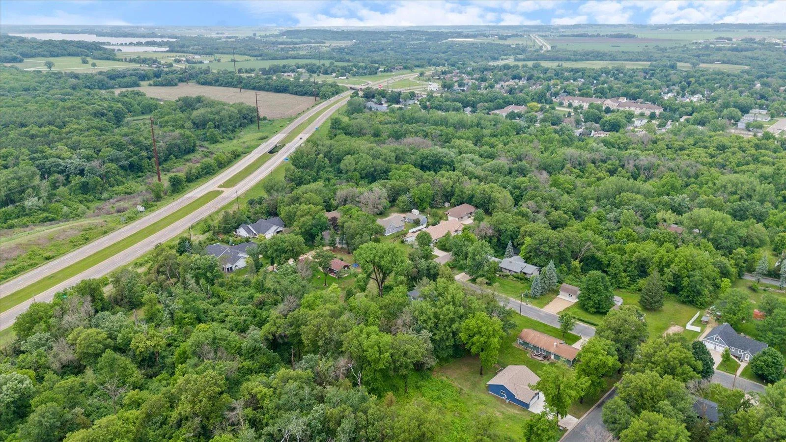 Aerial view of the home (the blue house in the lower right). The road on the left is US 52 that makes Rochester (Mayo Clinic), and the Twin Cities very accessible. Best of both worlds.