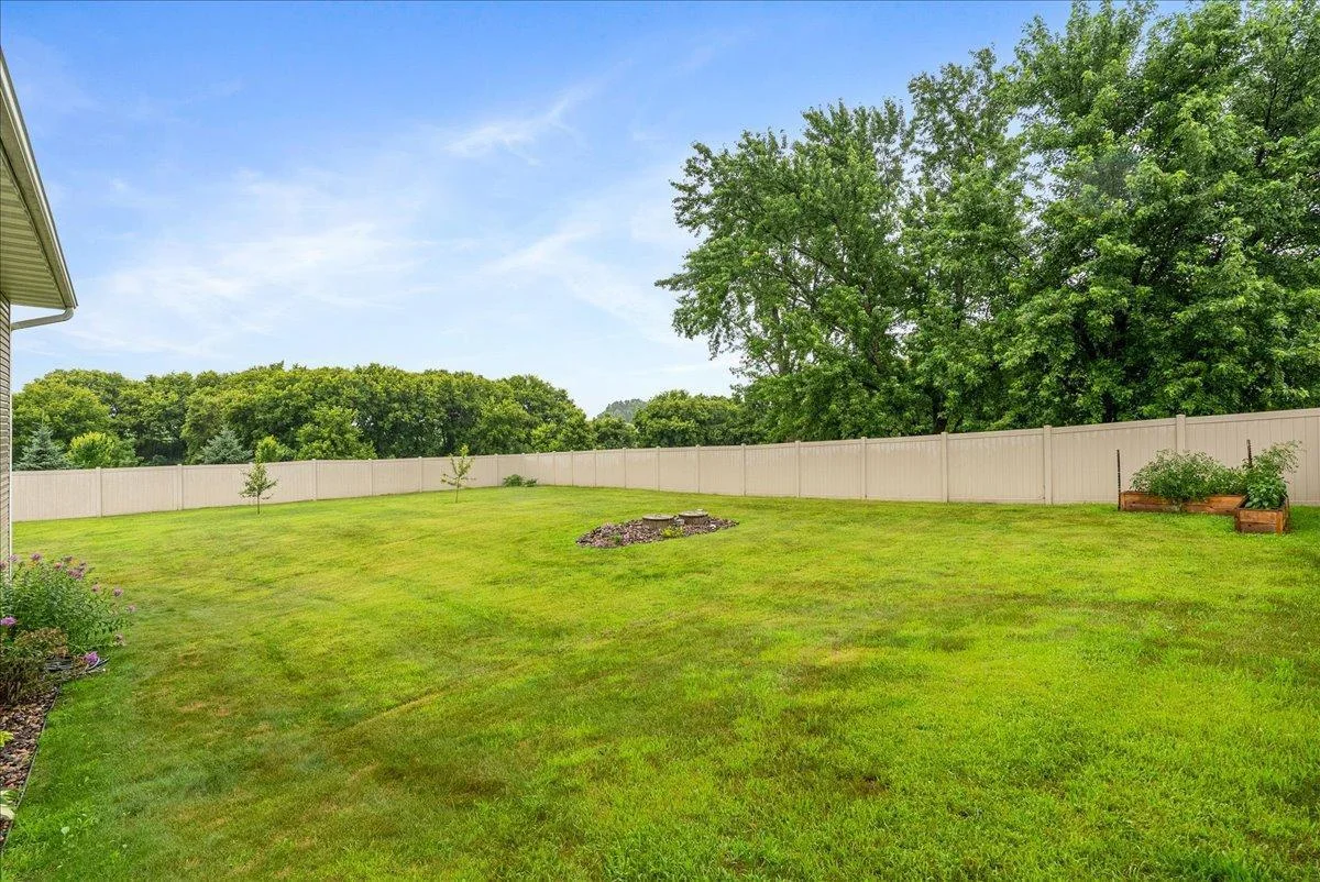 Gorgeous back yard with firepit and fruit trees along with beautiful landscaping