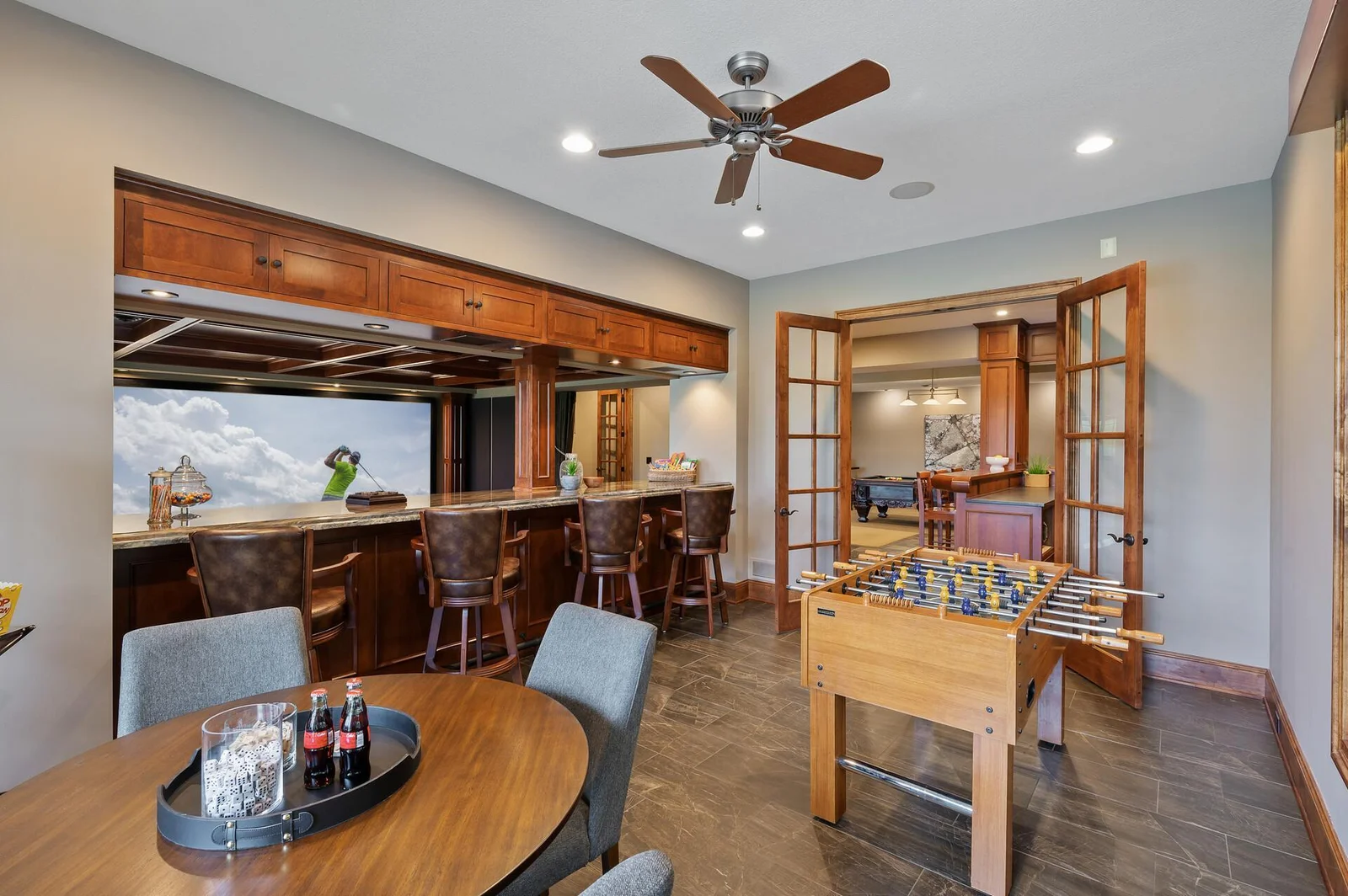 The well-appointed bar area on the lower level offers a convenient spot to serve guests while enjoying the theater room and other amenities on the lower level.
