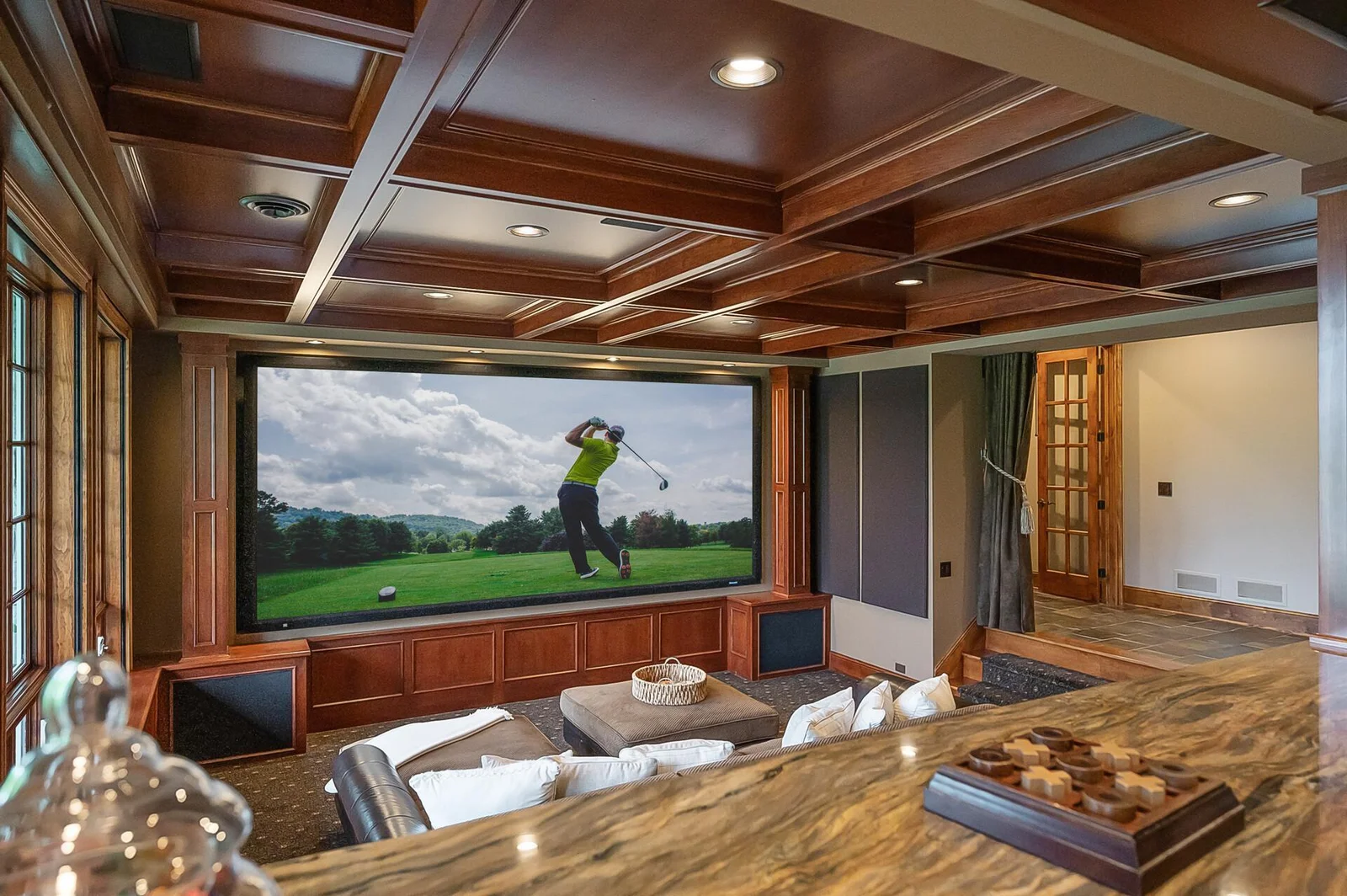 This custom theater, featured in the Wall Street Journal, offers an unparalleled entertainment experience with its 184-inch screen, 4K projection, plush seating, and a high-end sound system that brings every scene to life.