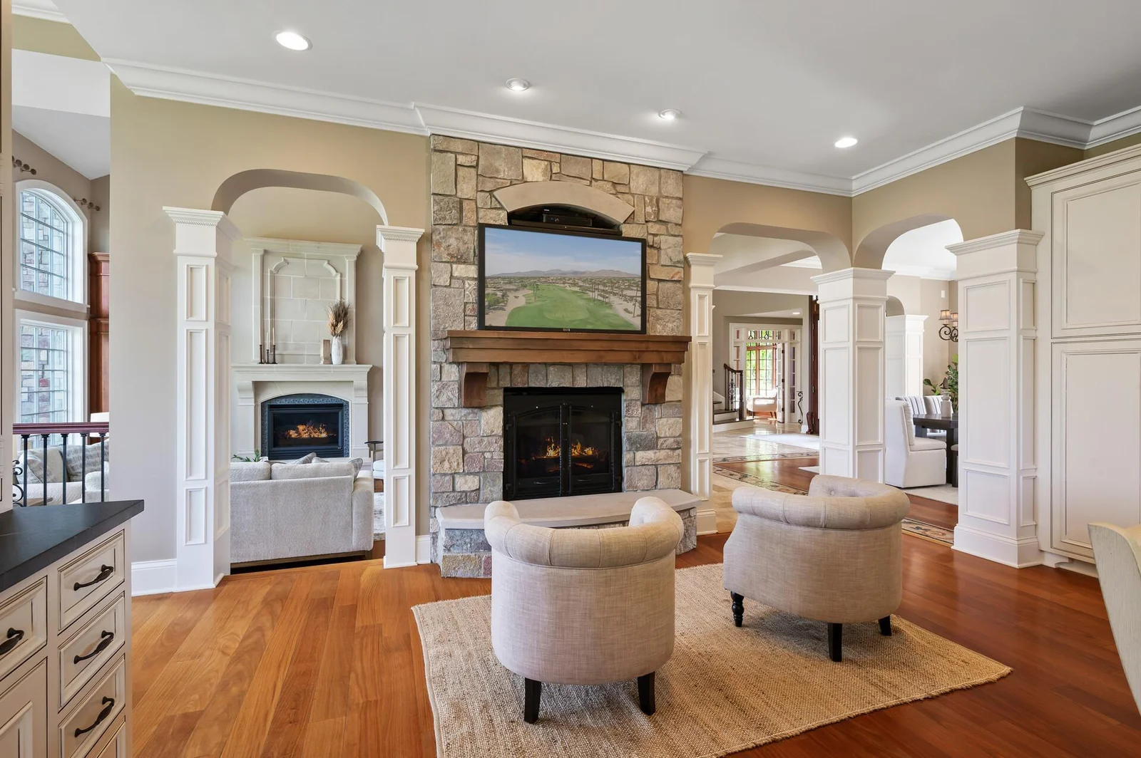 The thoughtful layout of this home includes a comfortable sitting room with stone surround fireplace, conveniently situated off the kitchen.