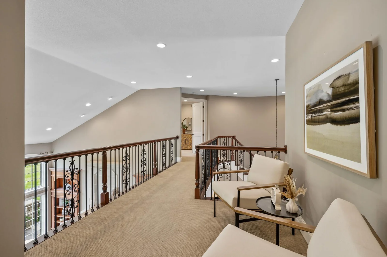 Enjoy the open and airy ambiance of the upper level landing, a versatile space for a cozy reading nook or sitting area.
