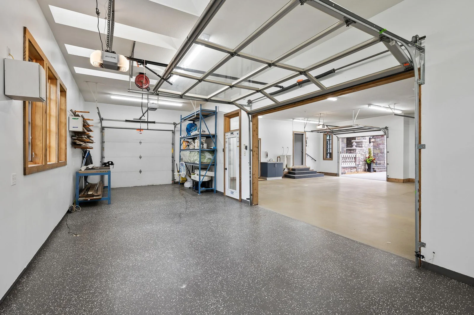 This versatile heated flex room, located within the 6-car garage, offers both interior access and its own garage door leading to the outside.