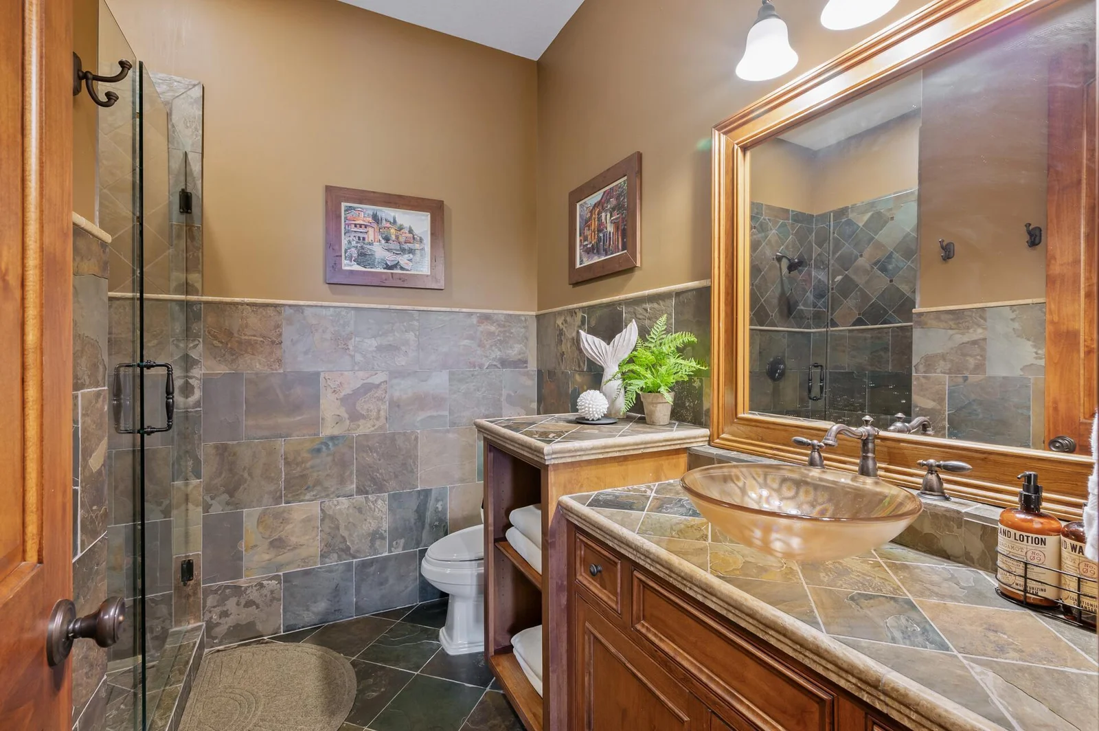 This conveniently located lower level bathroom features a walk-in shower, perfect for freshening up after enjoying the pool or entertainment areas.