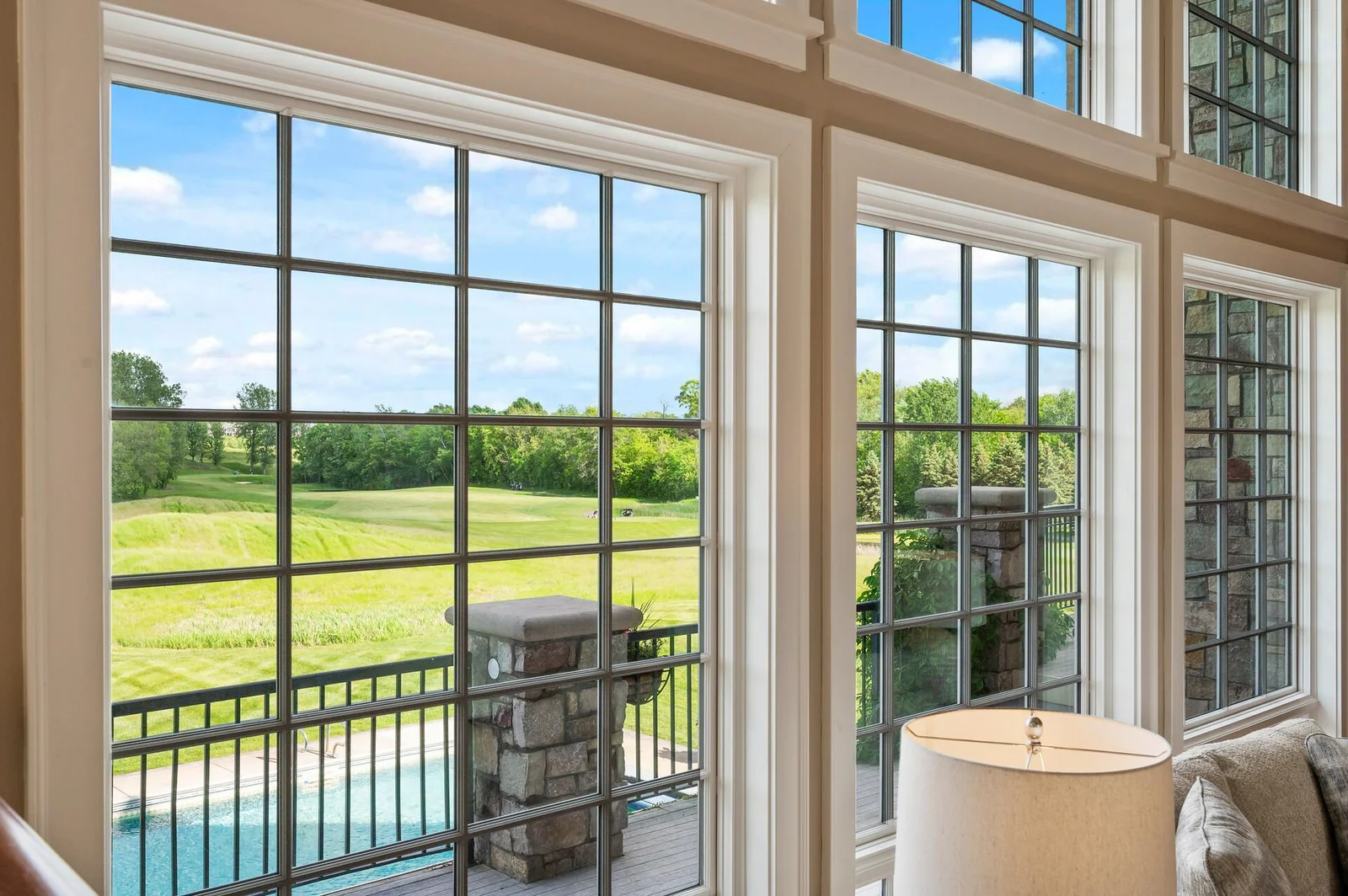 Expansive windows offering breathtaking views of the surrounding golf course.