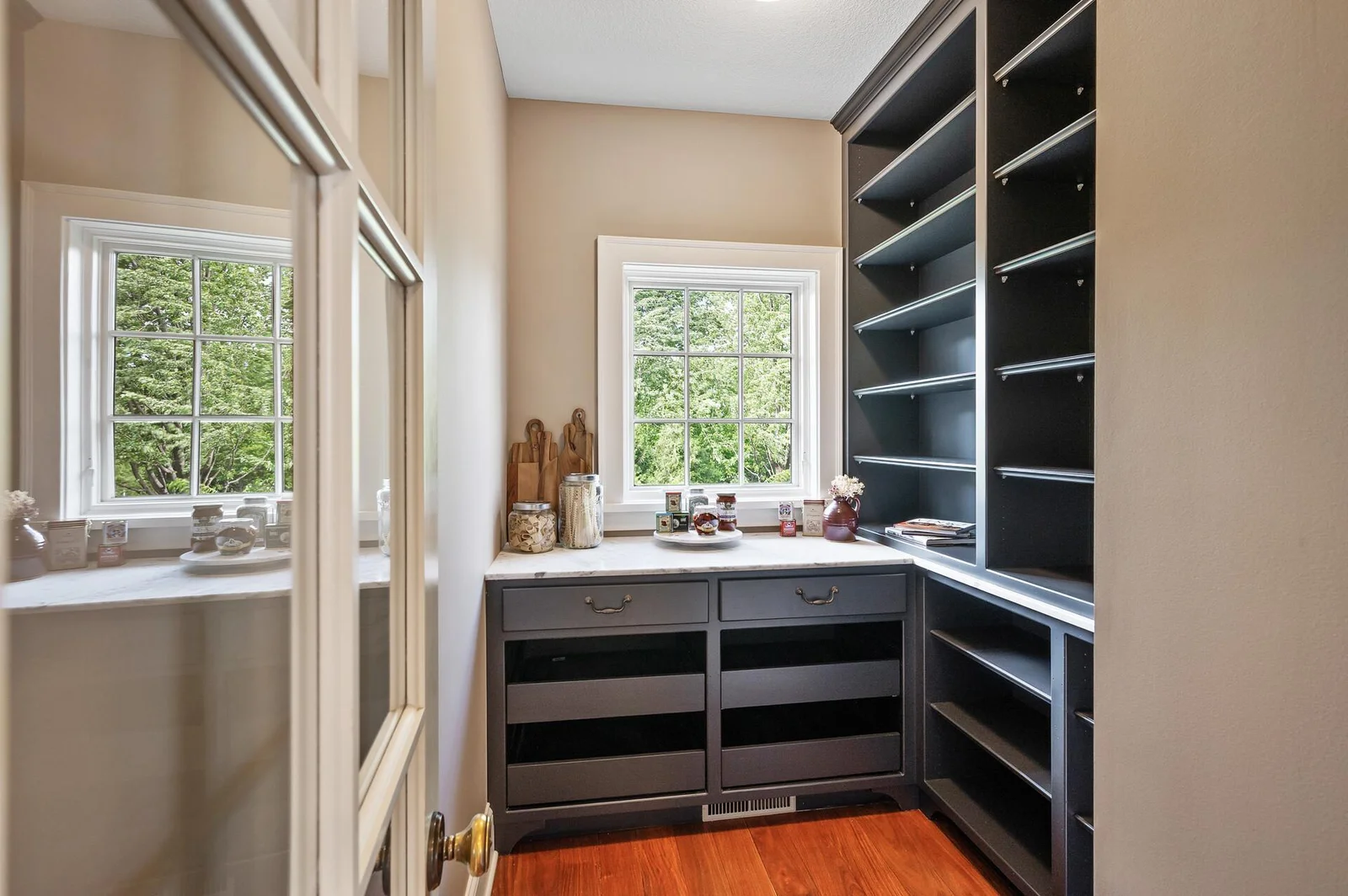 Designed for functionality, this walk-in pantry provides generous shelving and ample room for all your storage needs.