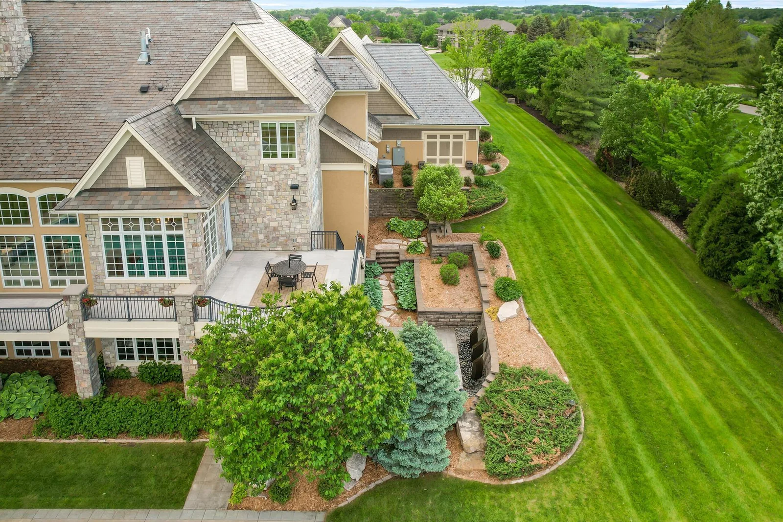 Offering various vantage points of the surrounding landscape, the spacious deck and lower patio provide exceptional outdoor living options.