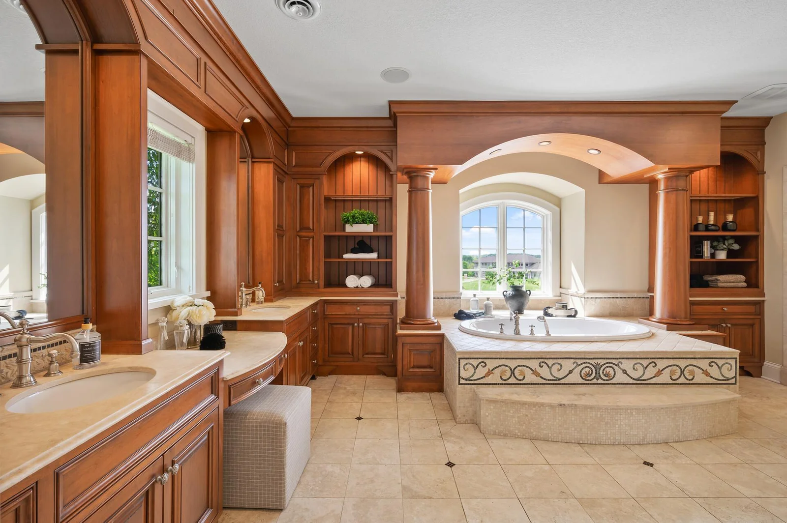 His and hers vanities and a stunning soaking tub create a luxurious and functional bathroom.