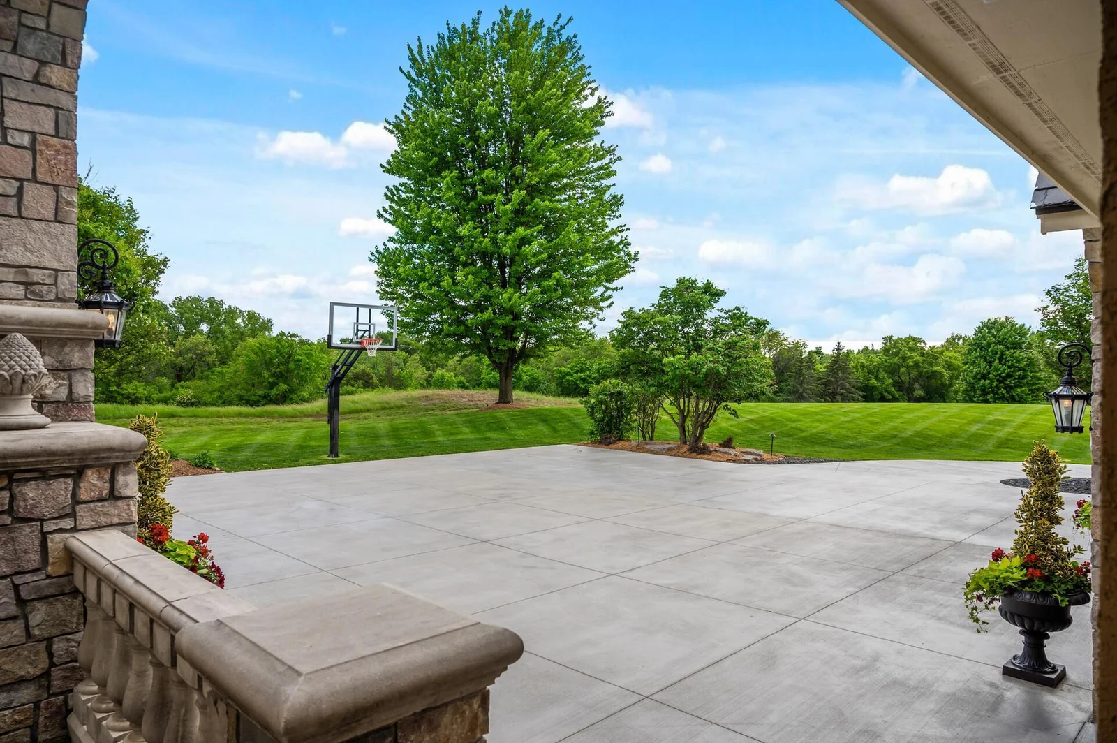 A modern touch with a new driveway, completed in the summer of 2024, elevates the already stunning front of this home. The expansive driveway offers ample parking and doubles as a fantastic sport court area, complete with a basketball hoop.