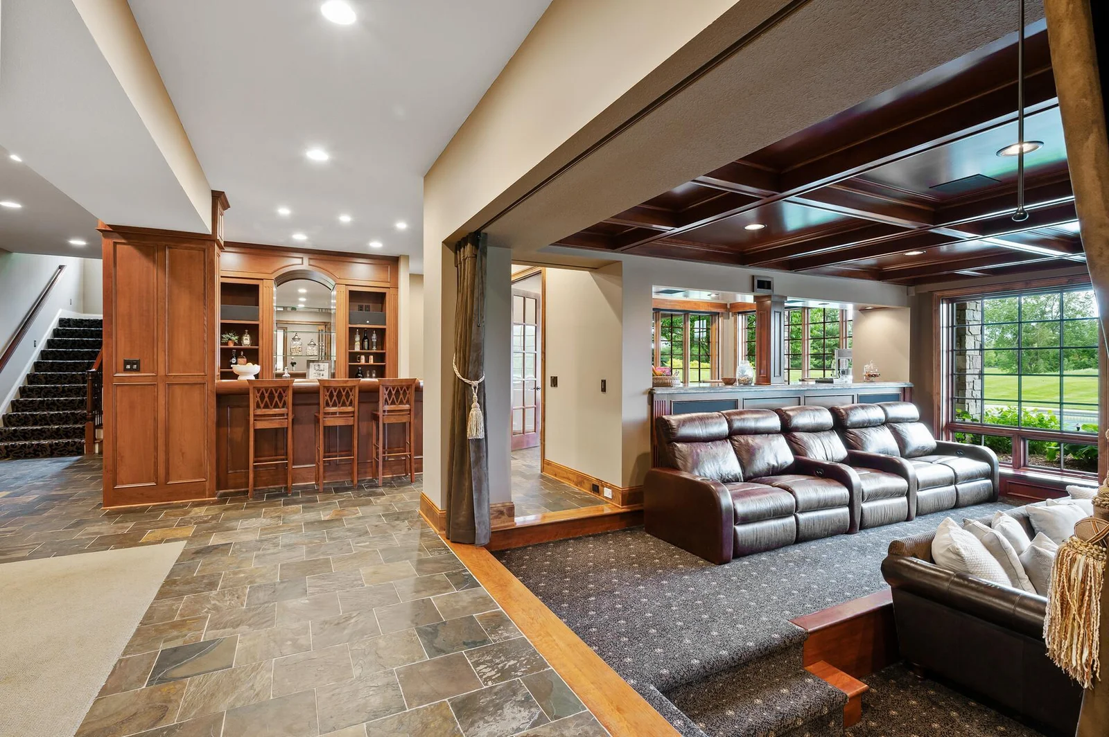 Completing the immersive theater experience are the custom drapes, a thoughtful and significant investment that adds to the room's acoustics and overall sophistication.