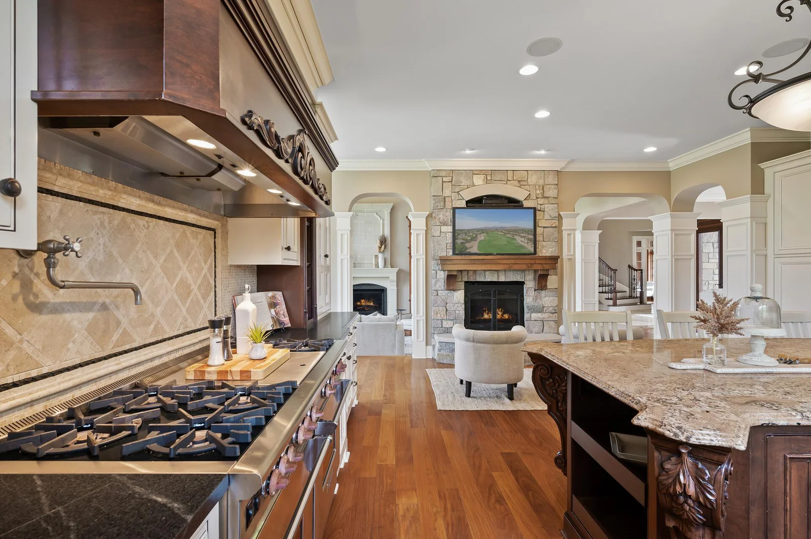 A chef's dream kitchen with a convenient island and adjacent sitting area.