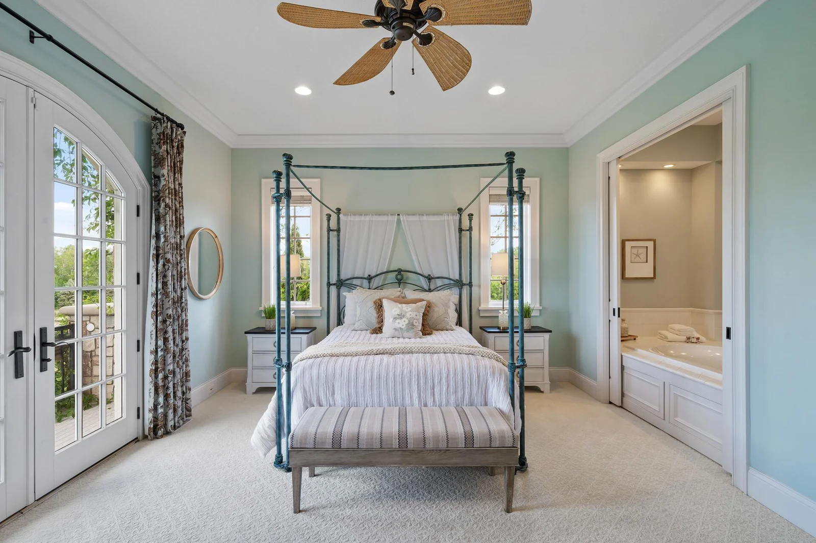 This primary suite offers a peaceful ambiance and convenient access to the ensuite bathroom.
