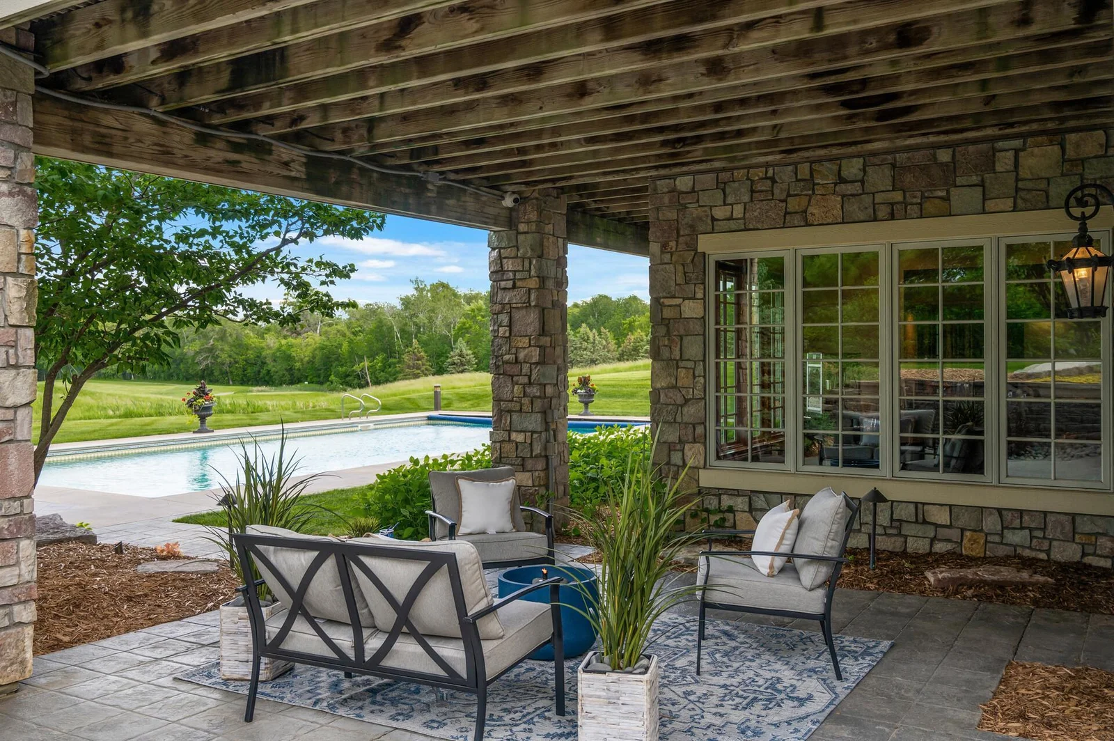 Find comfortable shade on this covered patio while still enjoying fantastic views of the pool and the meticulously landscaped grounds.
