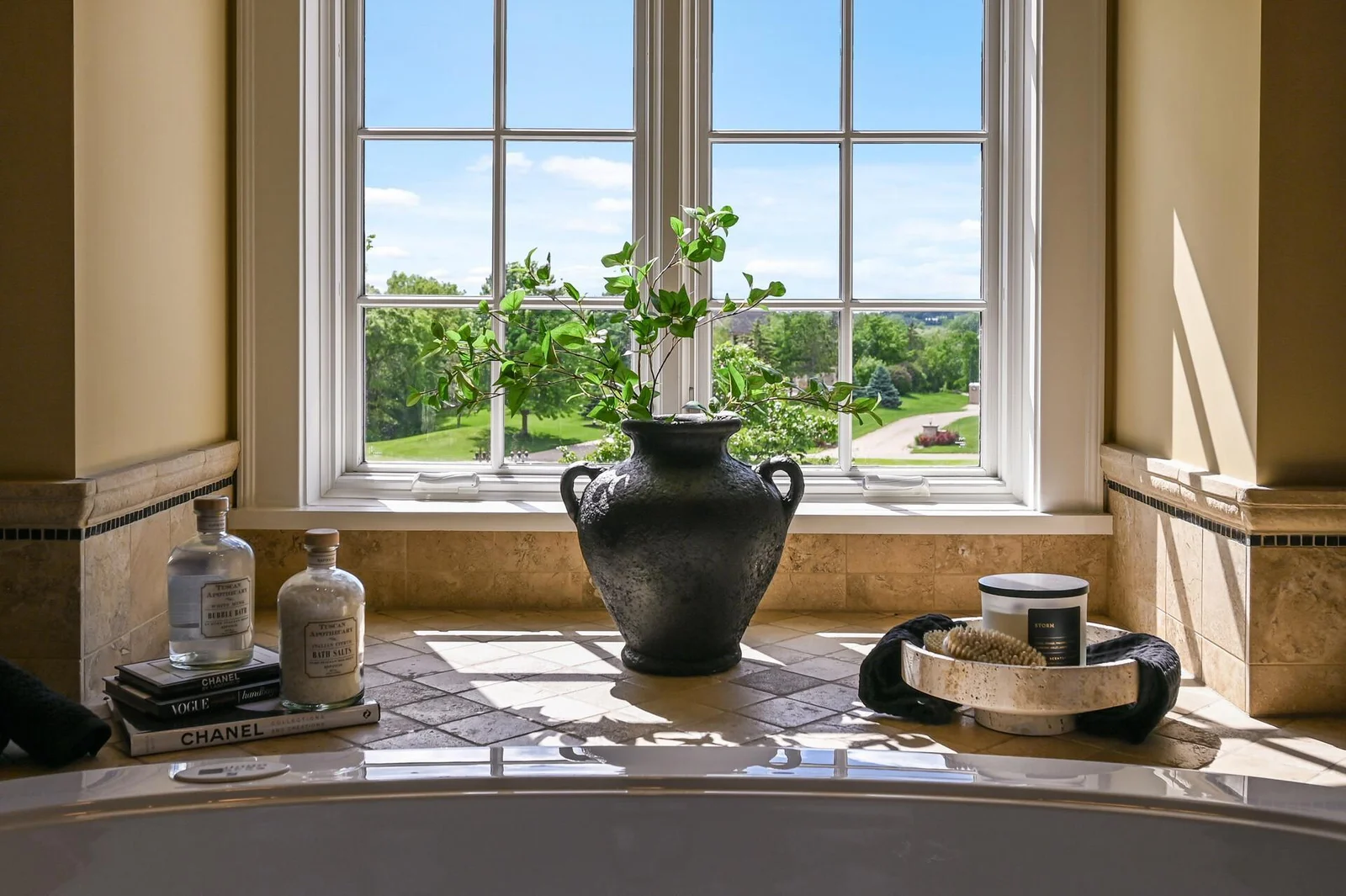 The beautiful window above the soaking tub brings the outdoors in.