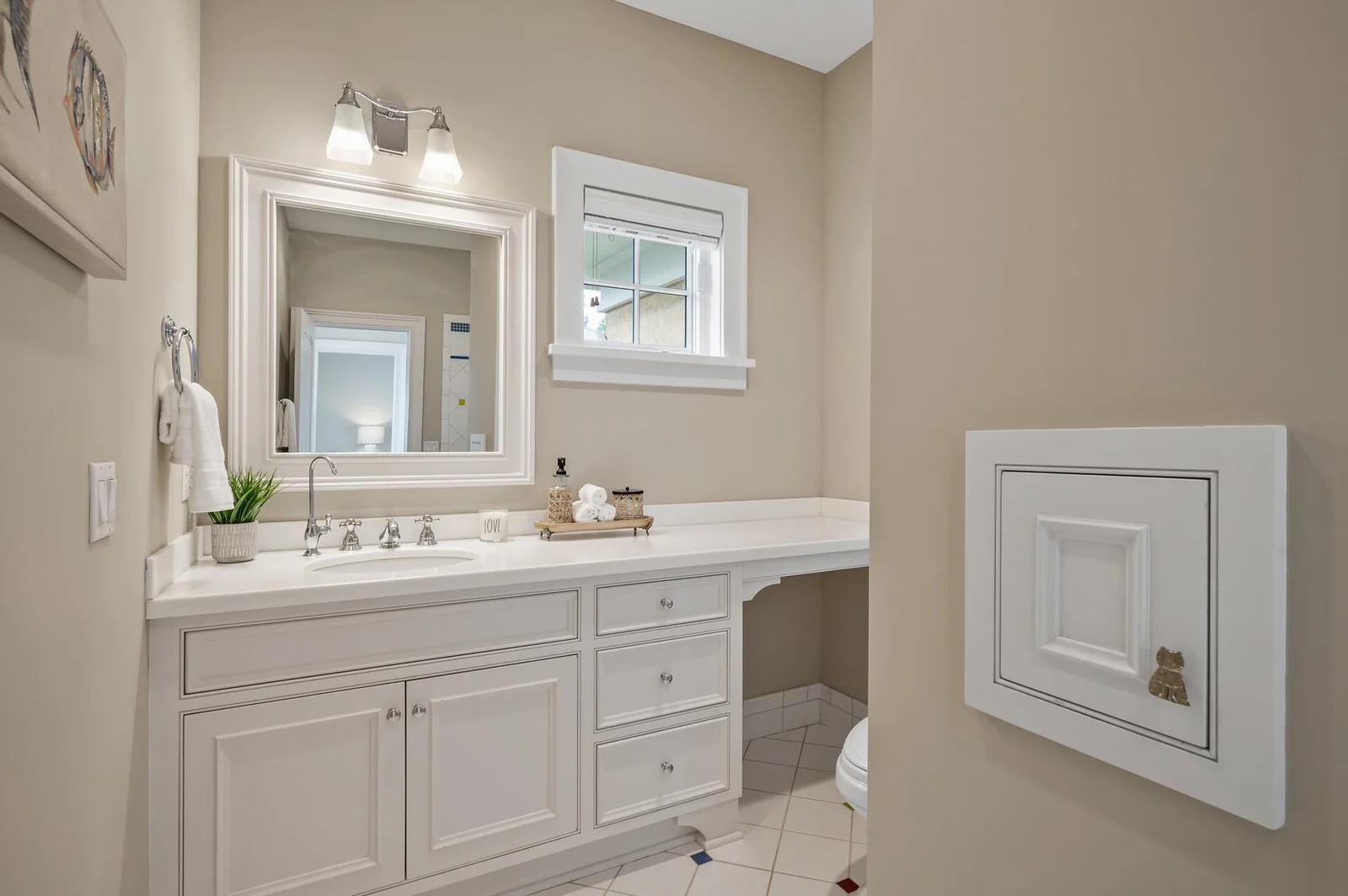 Bright and functional vanity area in this upper level bathroom, offering ample counter space and natural light.