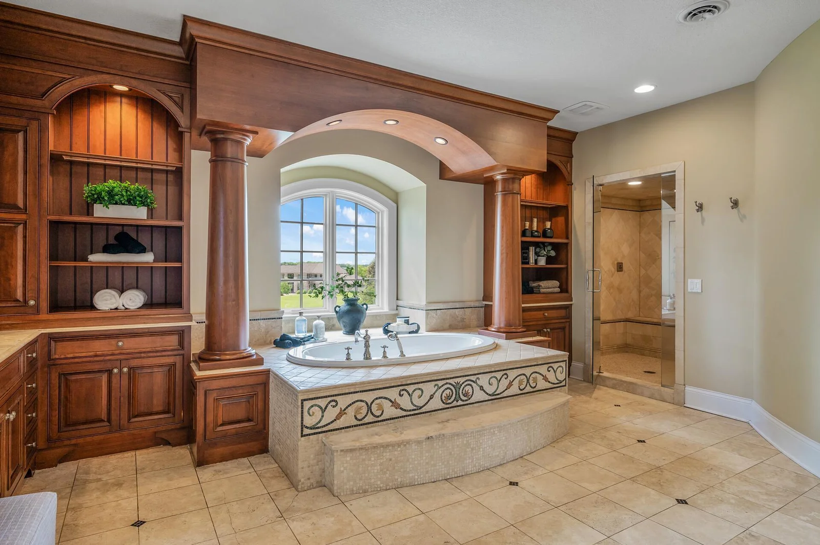Superior craftsmanship is evident in the meticulous custom tile detailing throughout the primary bathroom, a hallmark of this exceptional home.
