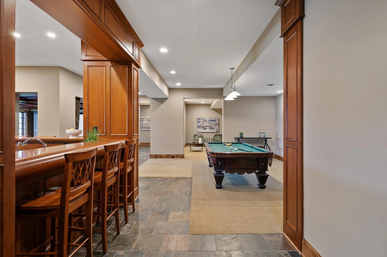 Perfect for both recreation and relaxation, the lower level offers a fun atmosphere with a billiard room and a welcoming bar area.