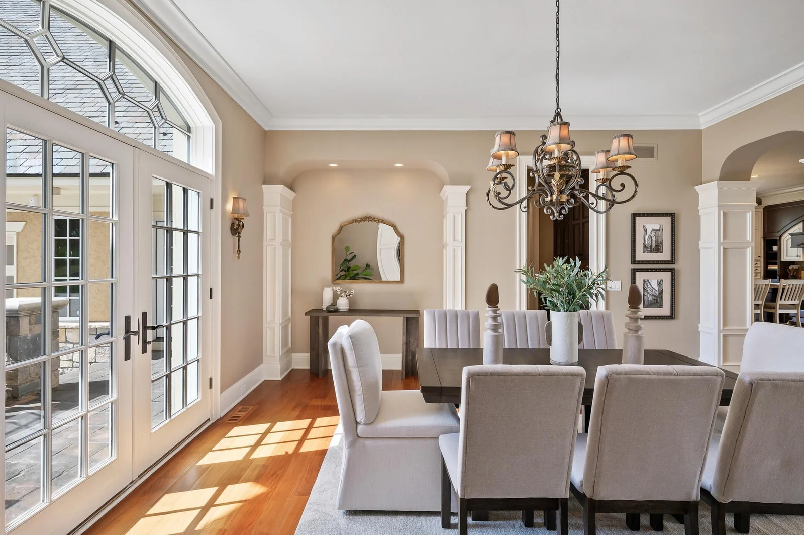 The beautiful French doors and hardwood floors create a sophisticated dining space.