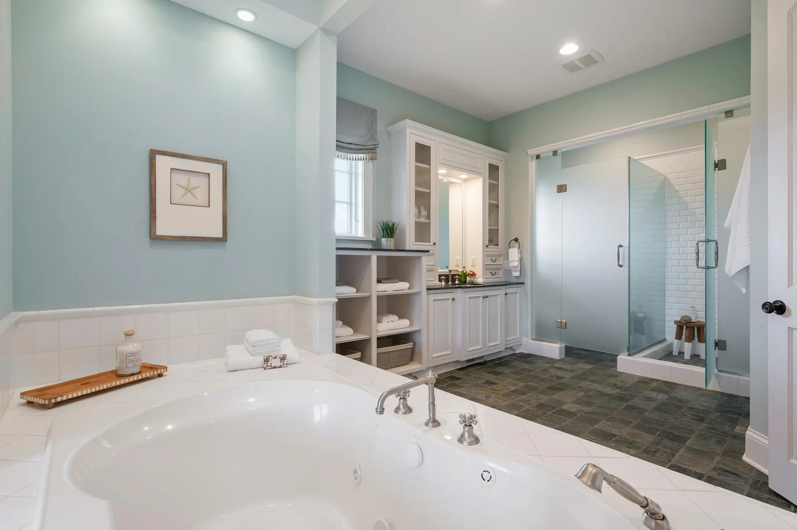 Thoughtfully designed, the primary ensuite features a well-defined layout with a separate shower and soaking tub, creating a functional and elegant space.