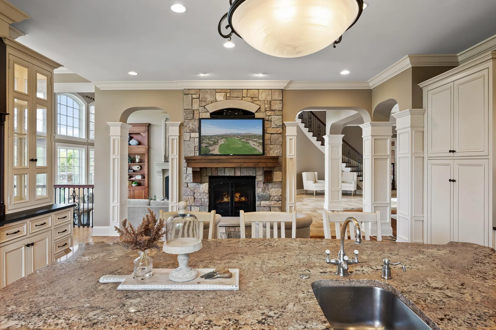 Beautiful granite kitchen island with a direct view of the charming sitting room and its stone fireplace.