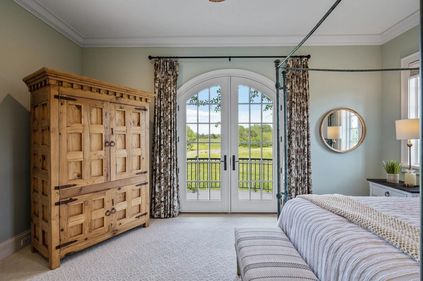 Wake up to beautiful views and easy outdoor access from this main-level primary suite.