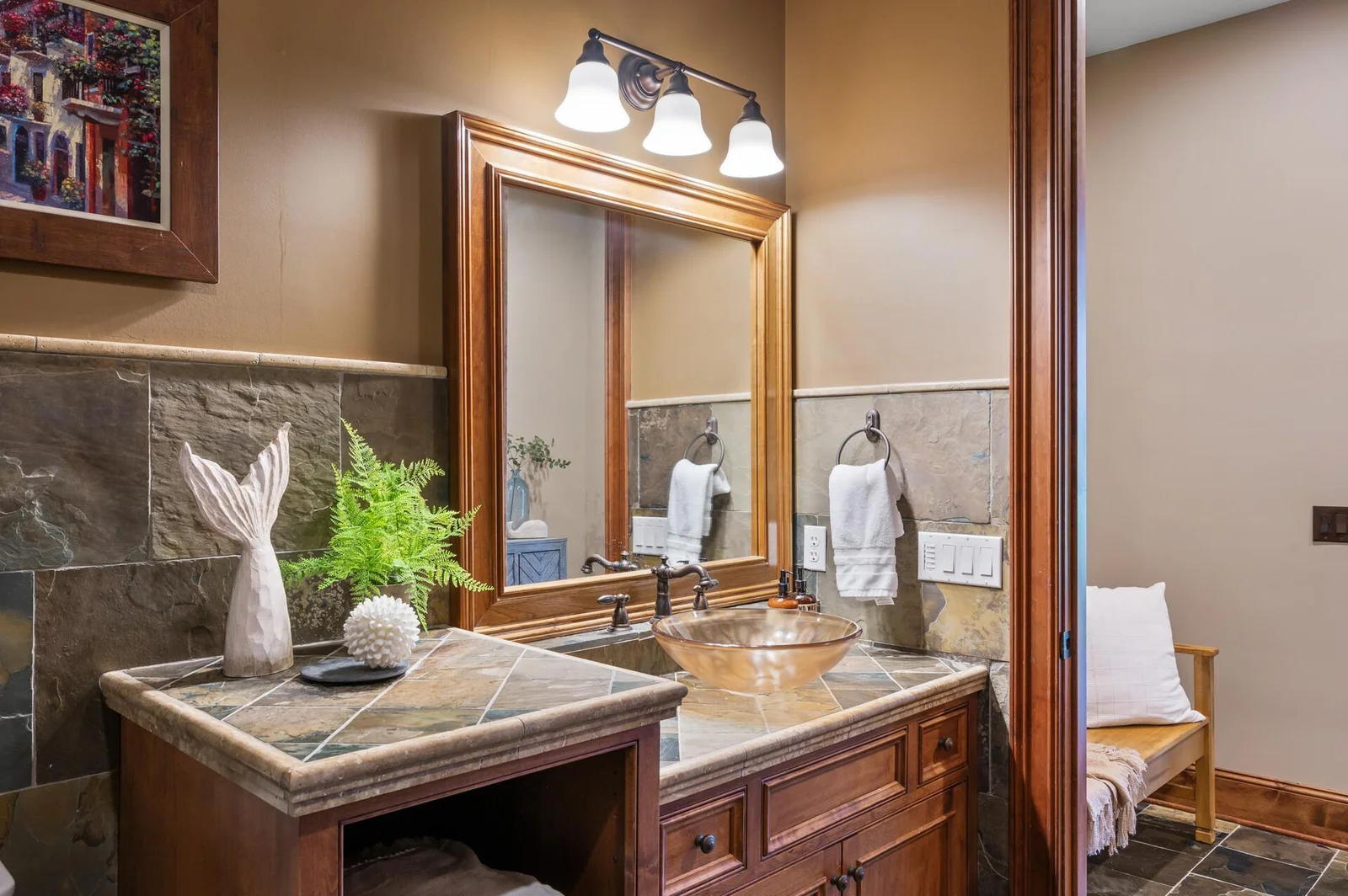 Stylish vanity with a unique vessel sink in the lower level bathroom.